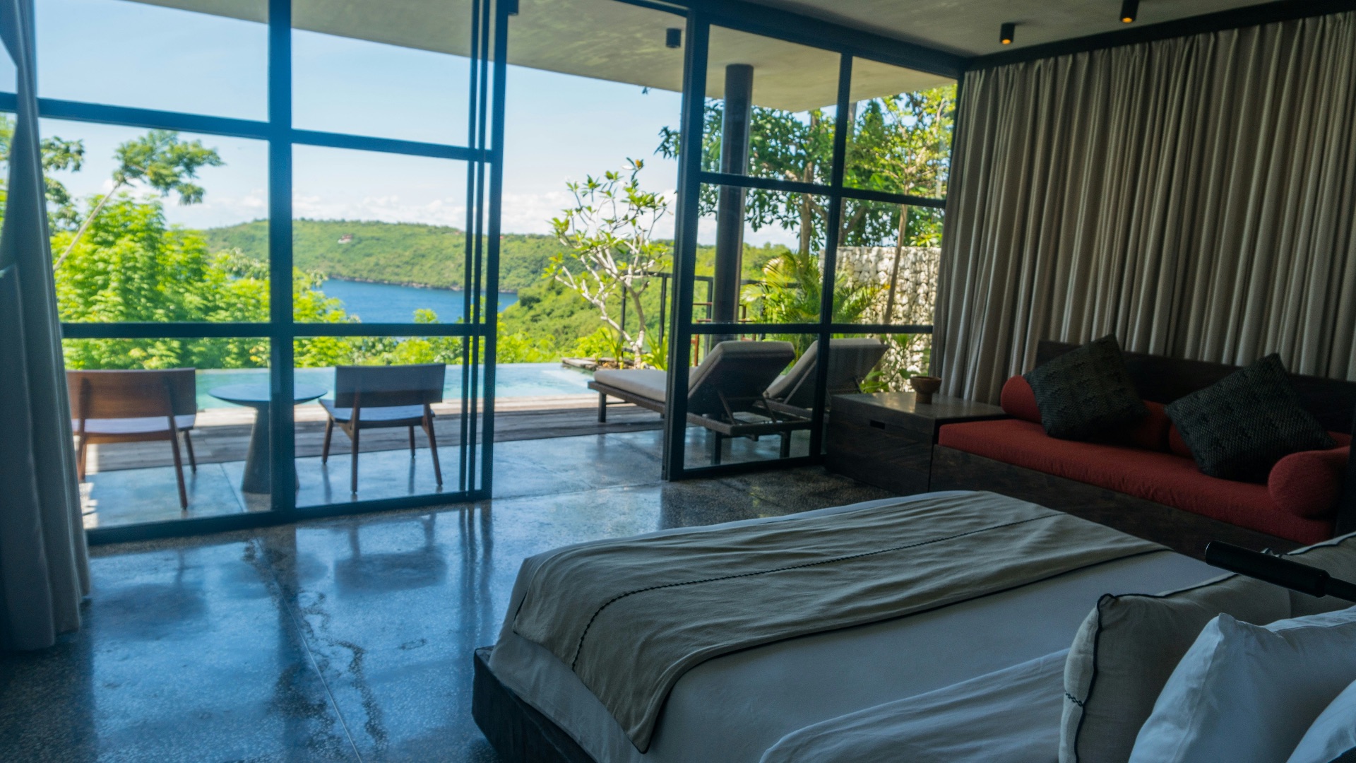 A bedroom with a large bed and a large window
