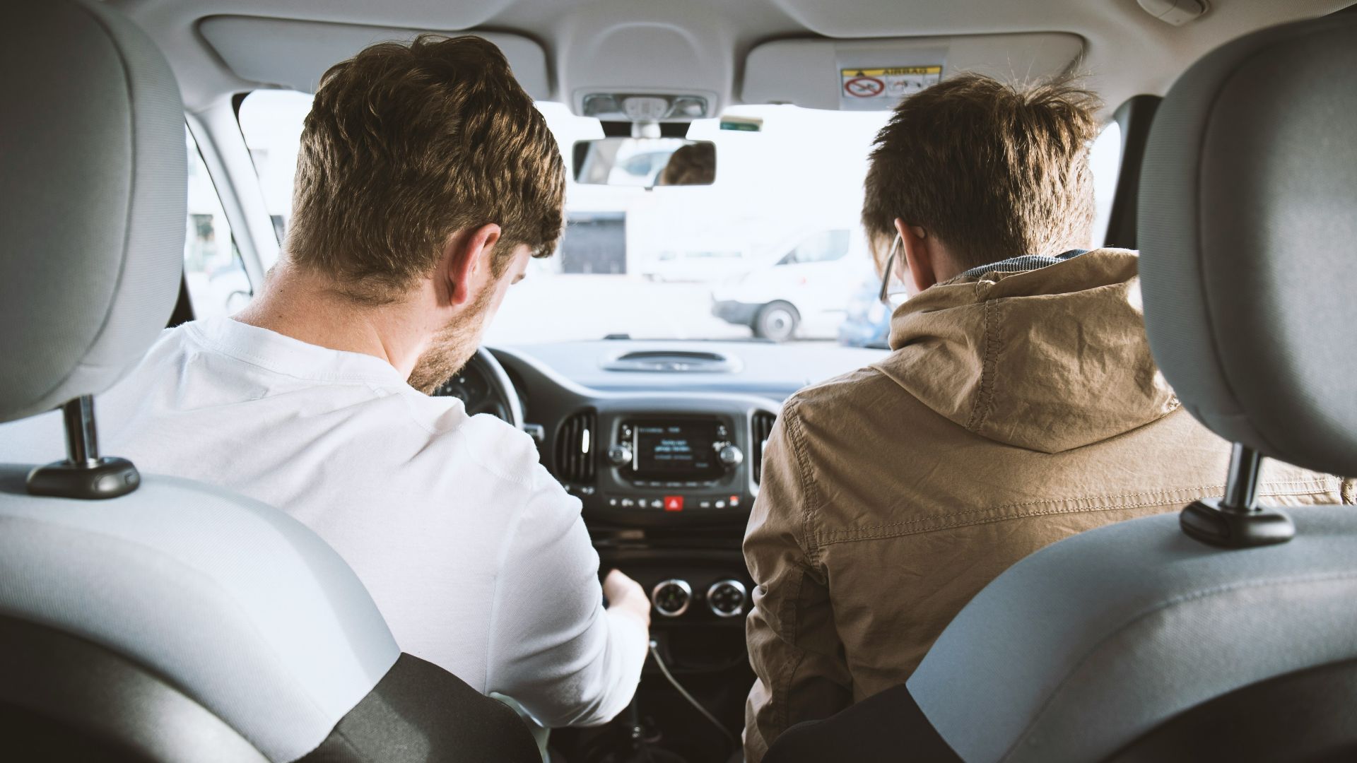 two men sitting inside vehicle