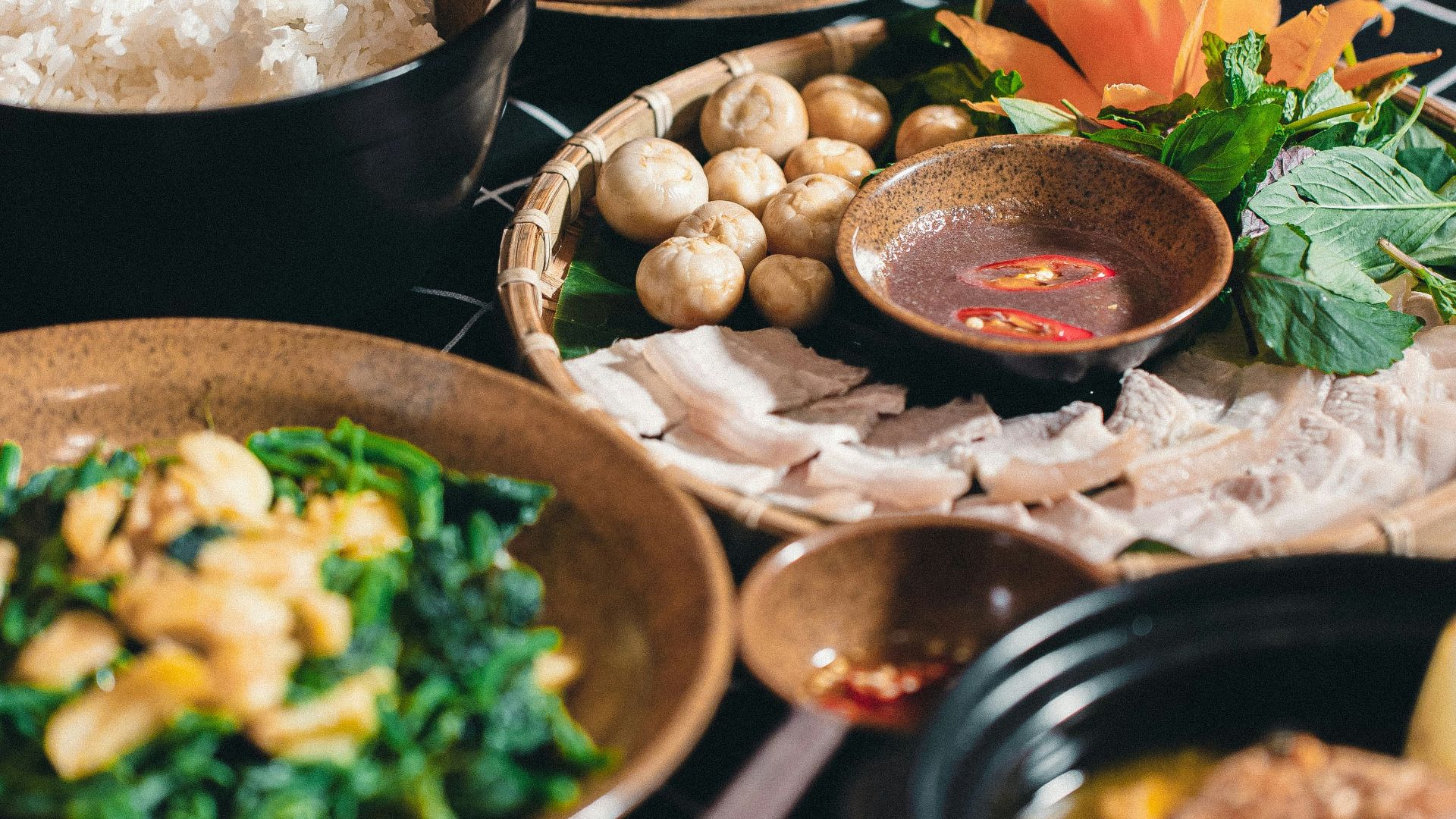 a table topped with lots of different bowls of food