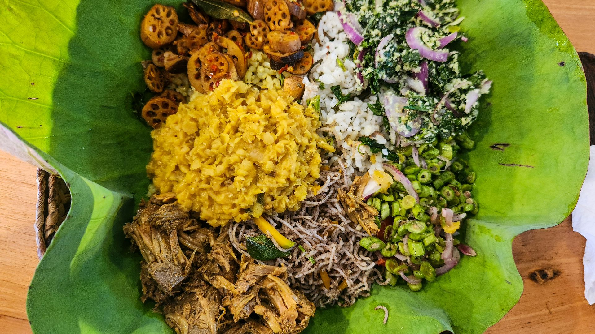 A sri lankan meal is presented on a leaf.