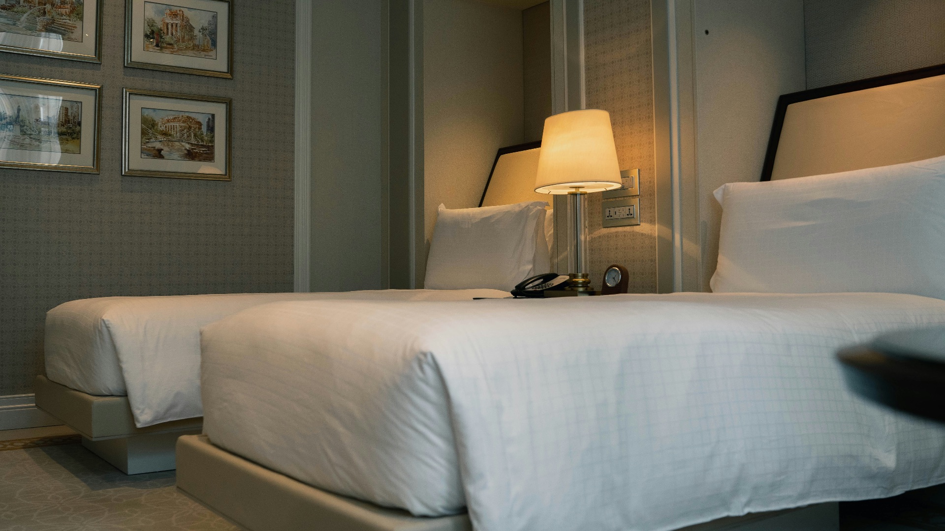 white bed linen with white table lamp