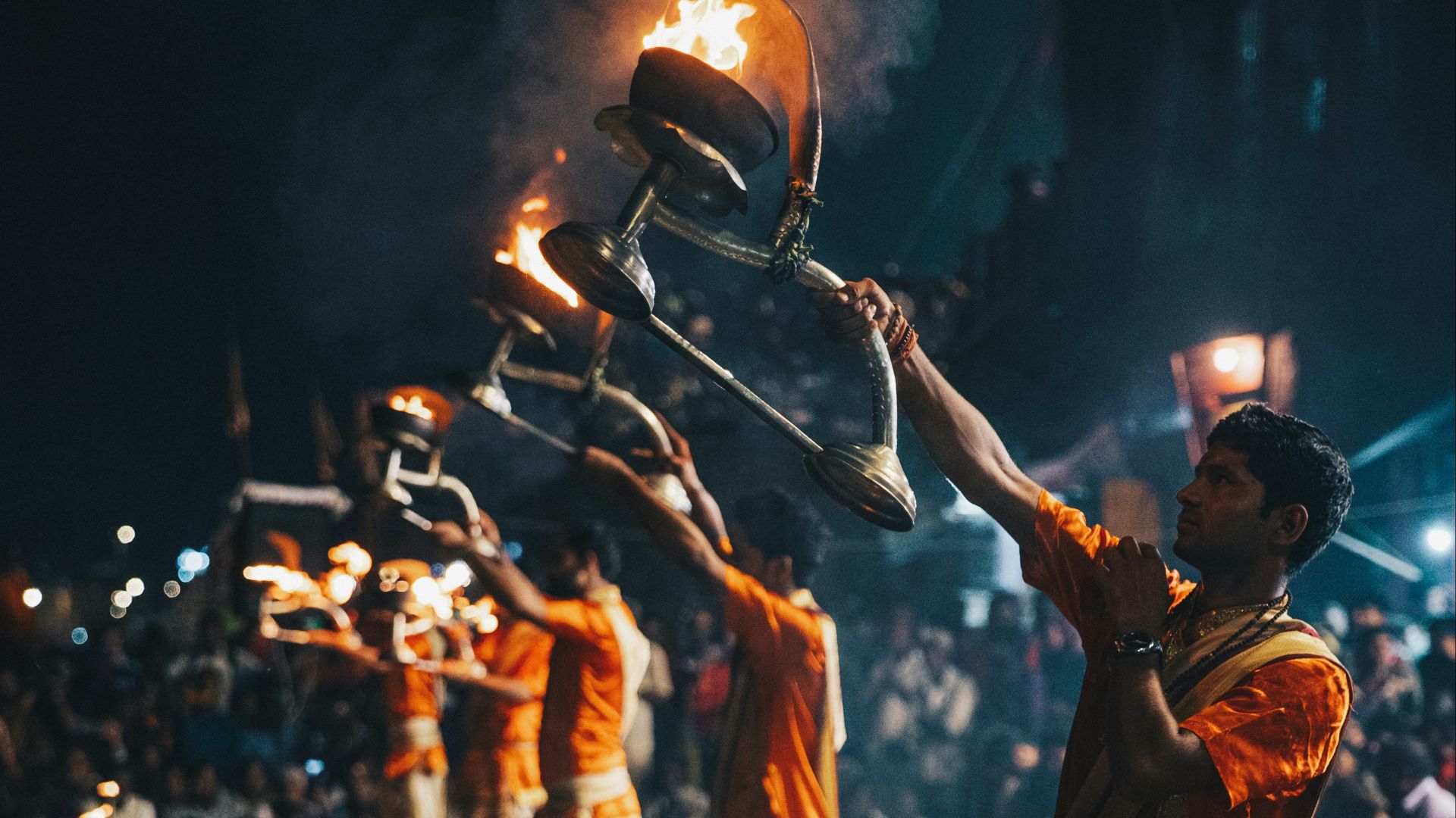 man in brown shirt and pants standing on gray concrete floor