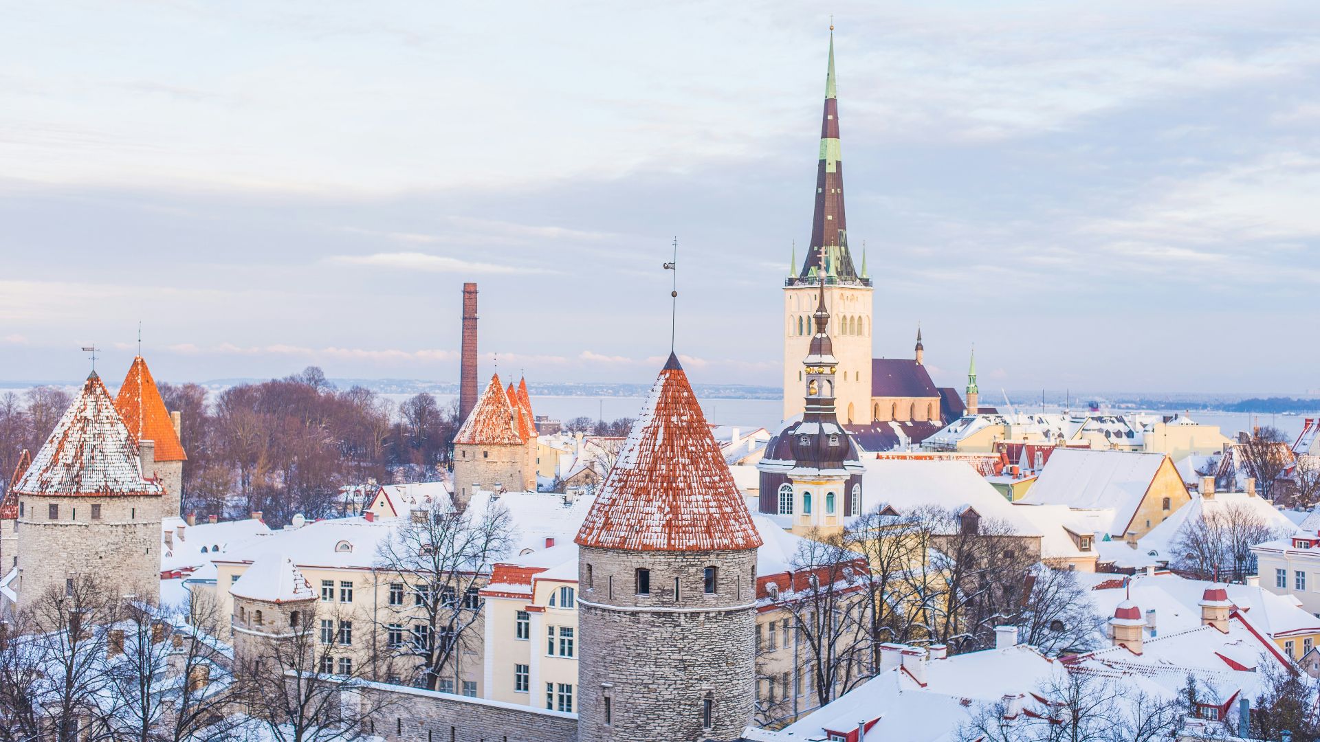 snow covered brown, white, and gray concrete castle under cloudy skies