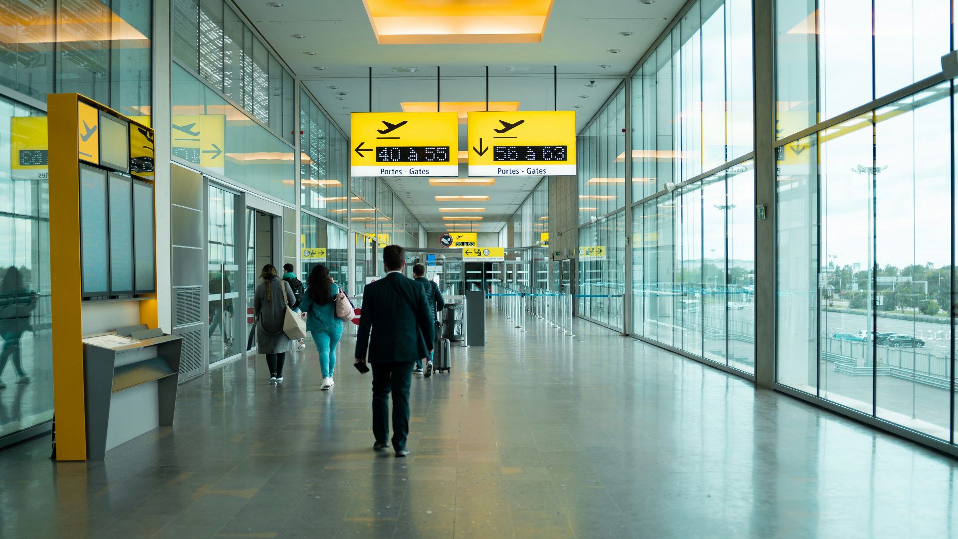 man in black jacket walking on hallway