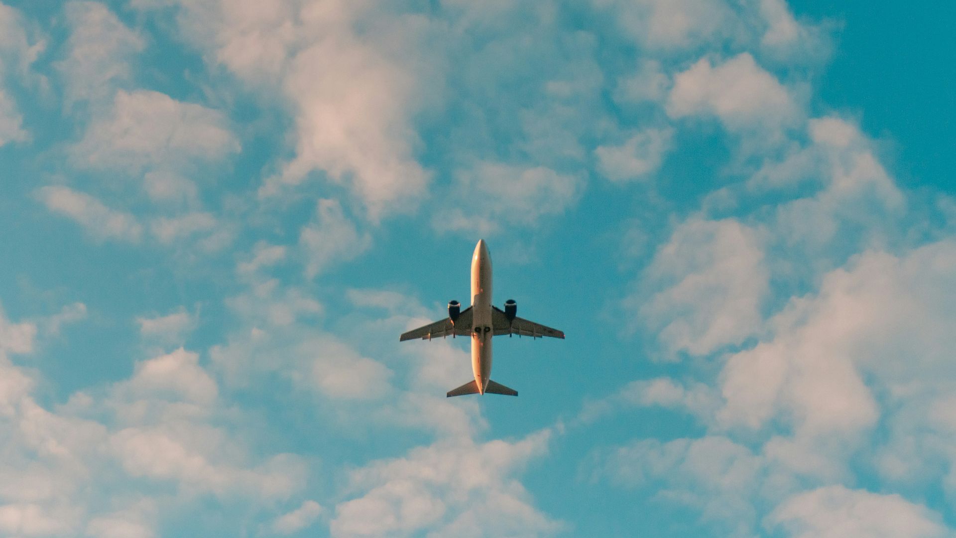 white airplane flying in the sky during daytime