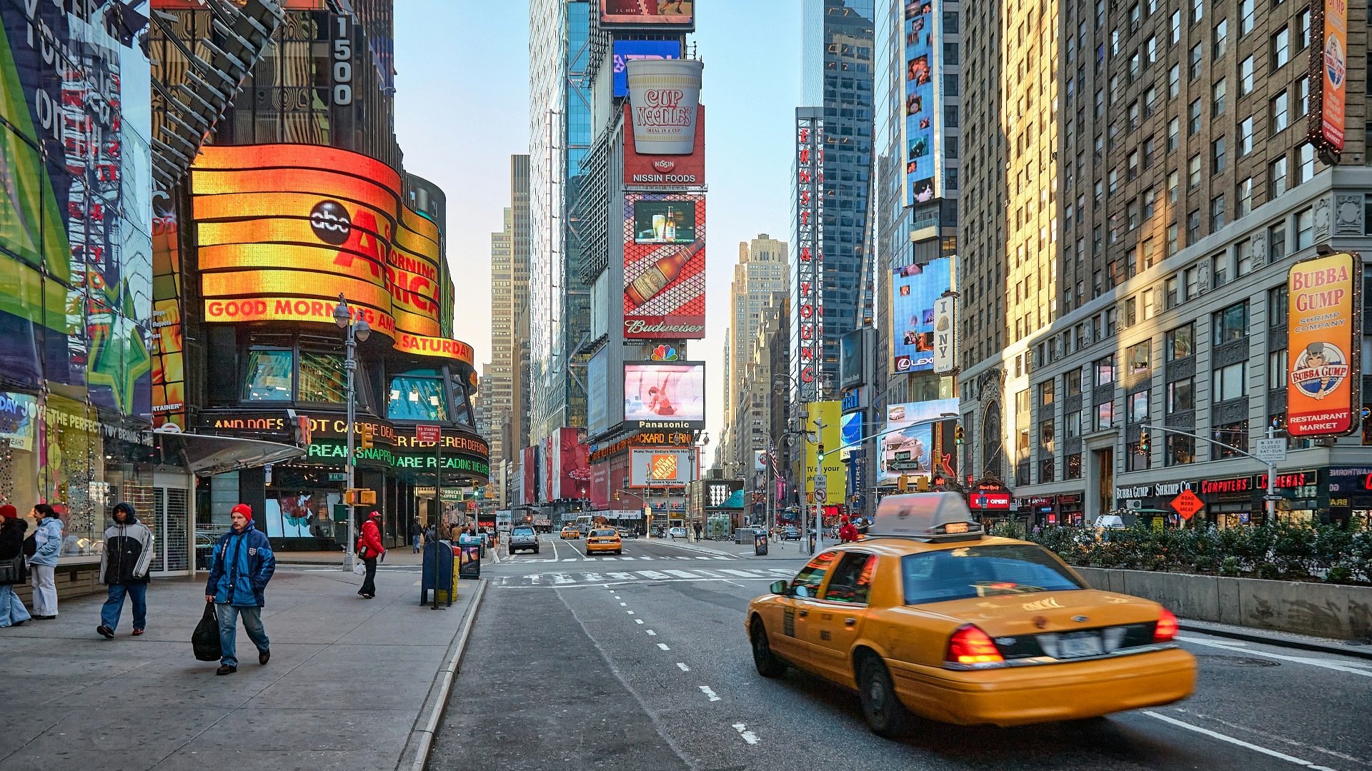 cars on road near high rise buildings during daytime
