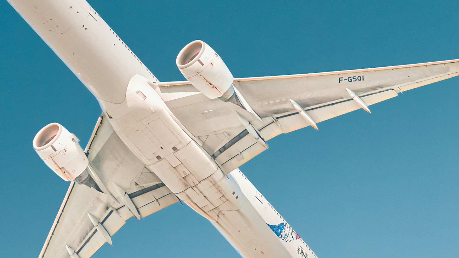 white airplane under blue sky during daytime