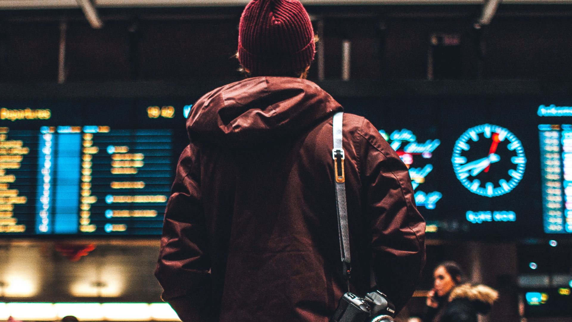 person looking up to the flight schedules