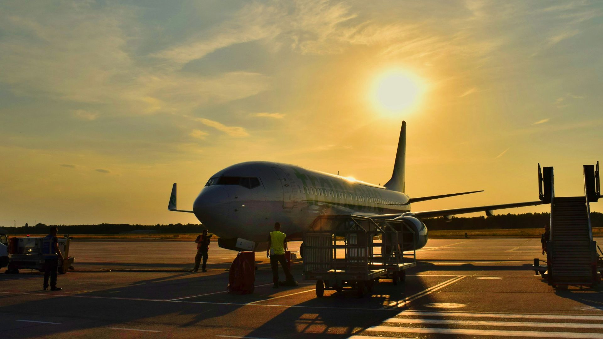 white airplane parked during daytime