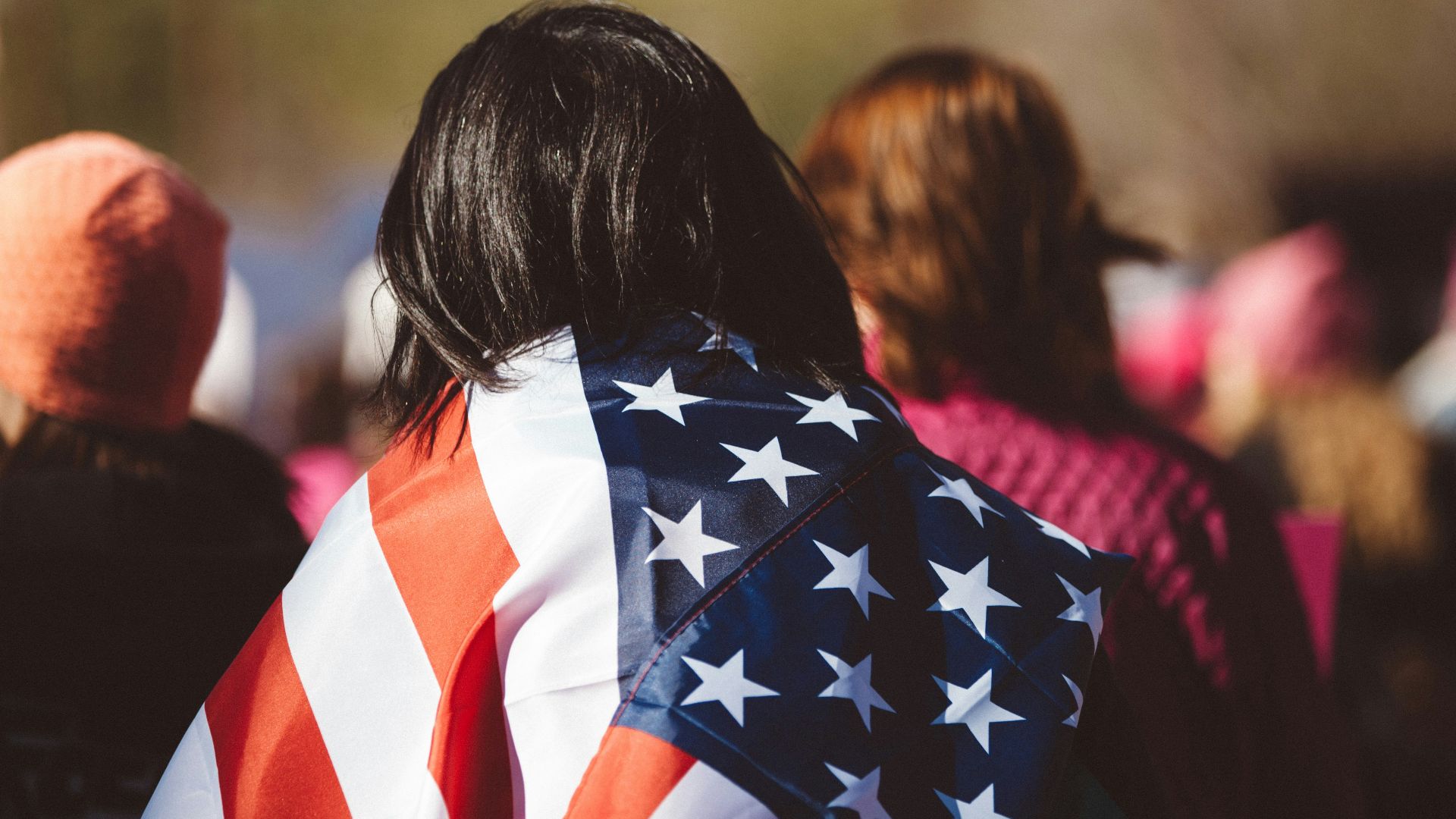 woman with US American flag on her shoulders