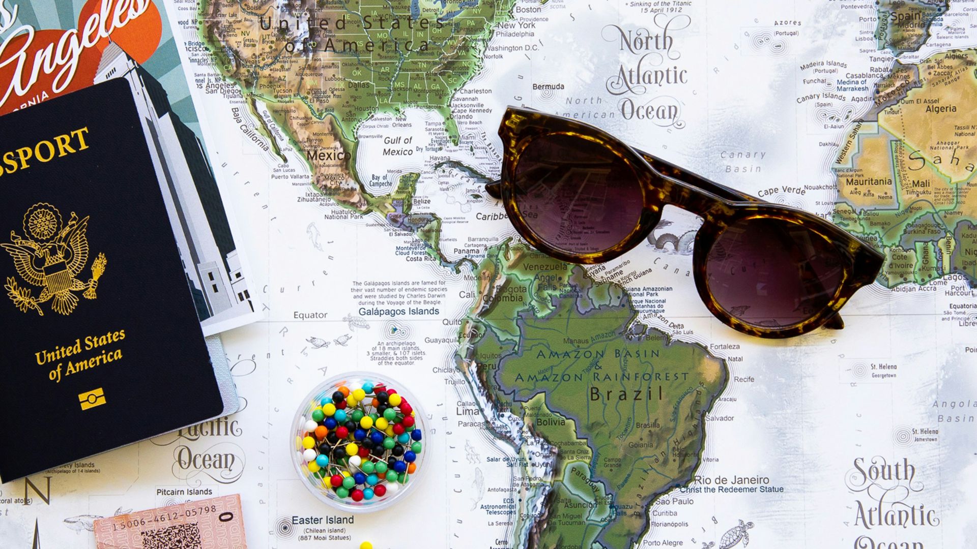 brown framed sunglasses on map