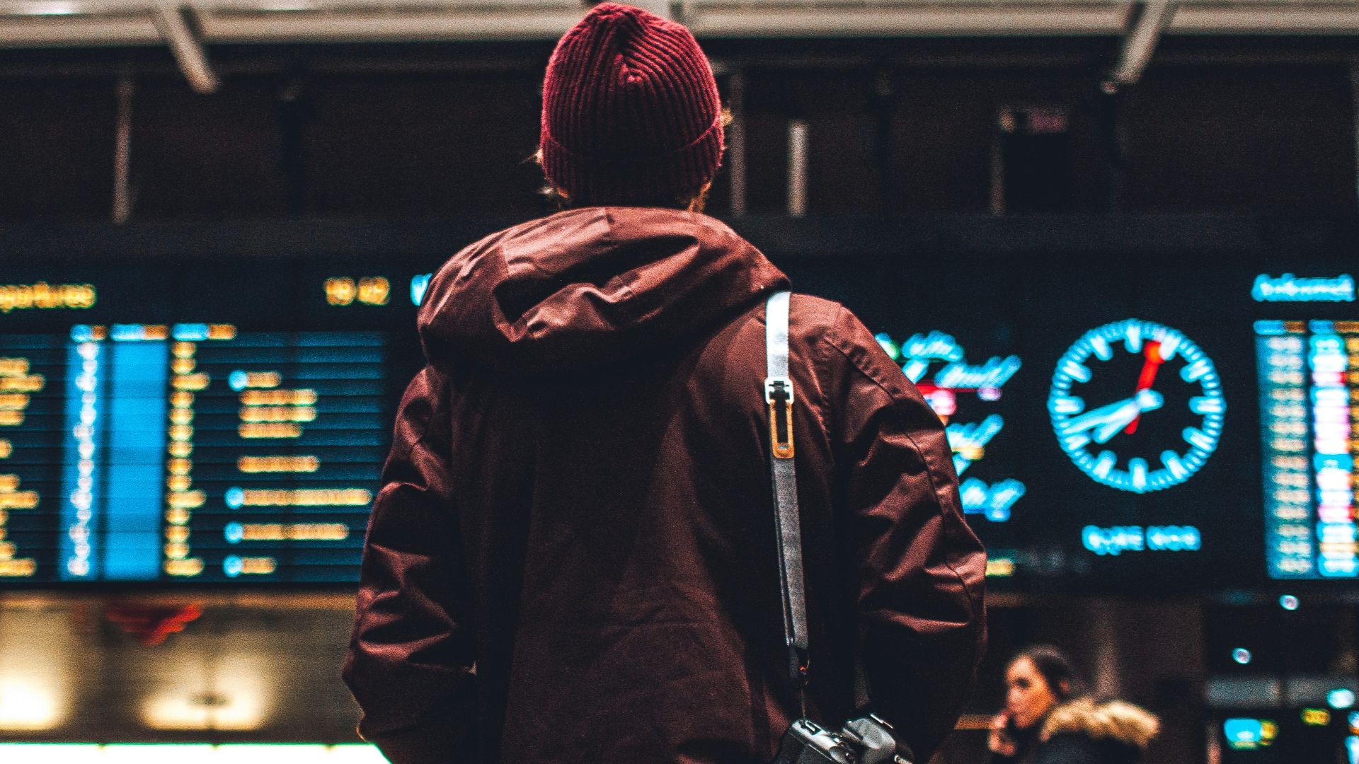 person looking up to the flight schedules