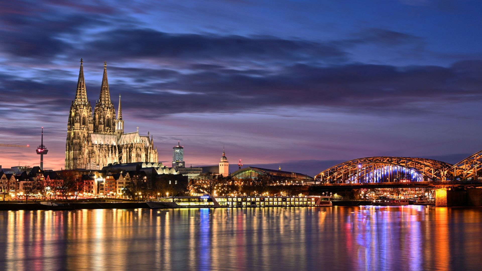 lighted city buildings near body of water