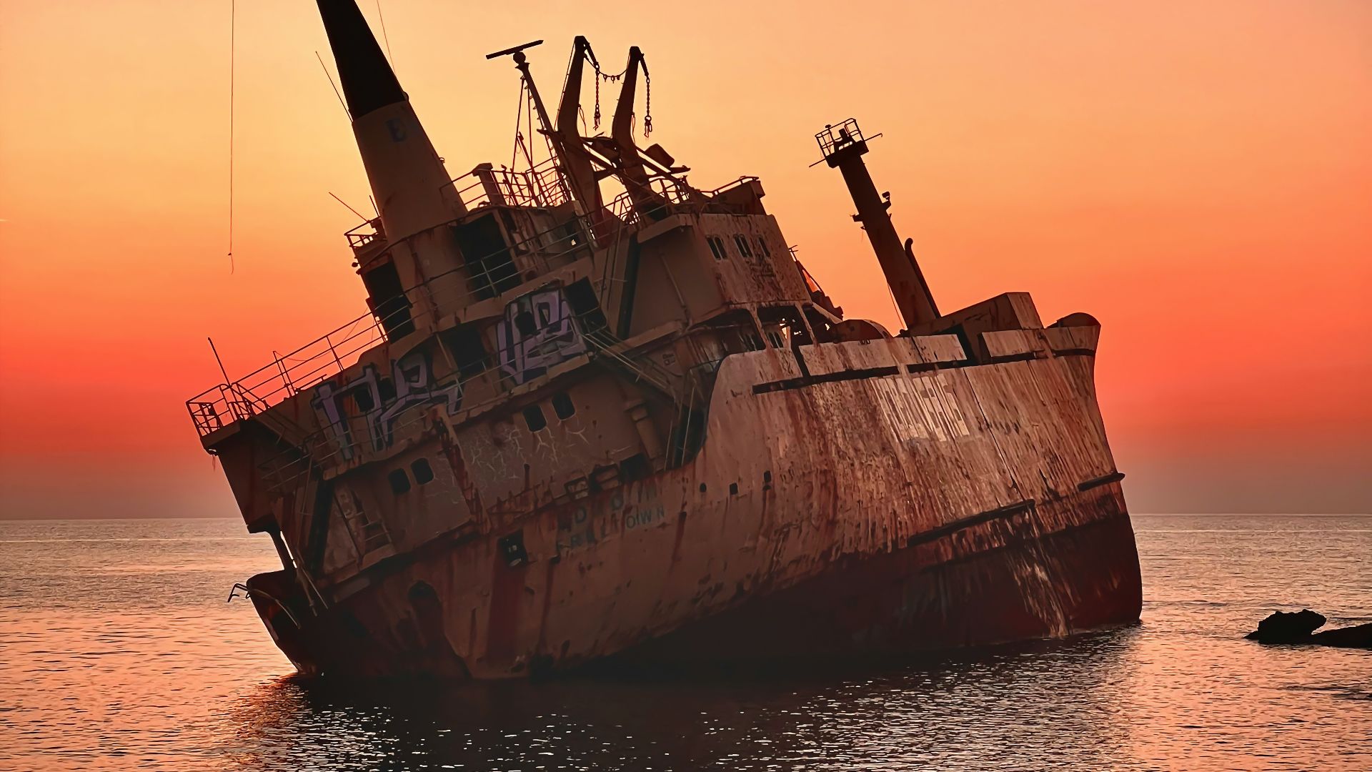 an old rusted ship in the middle of the ocean