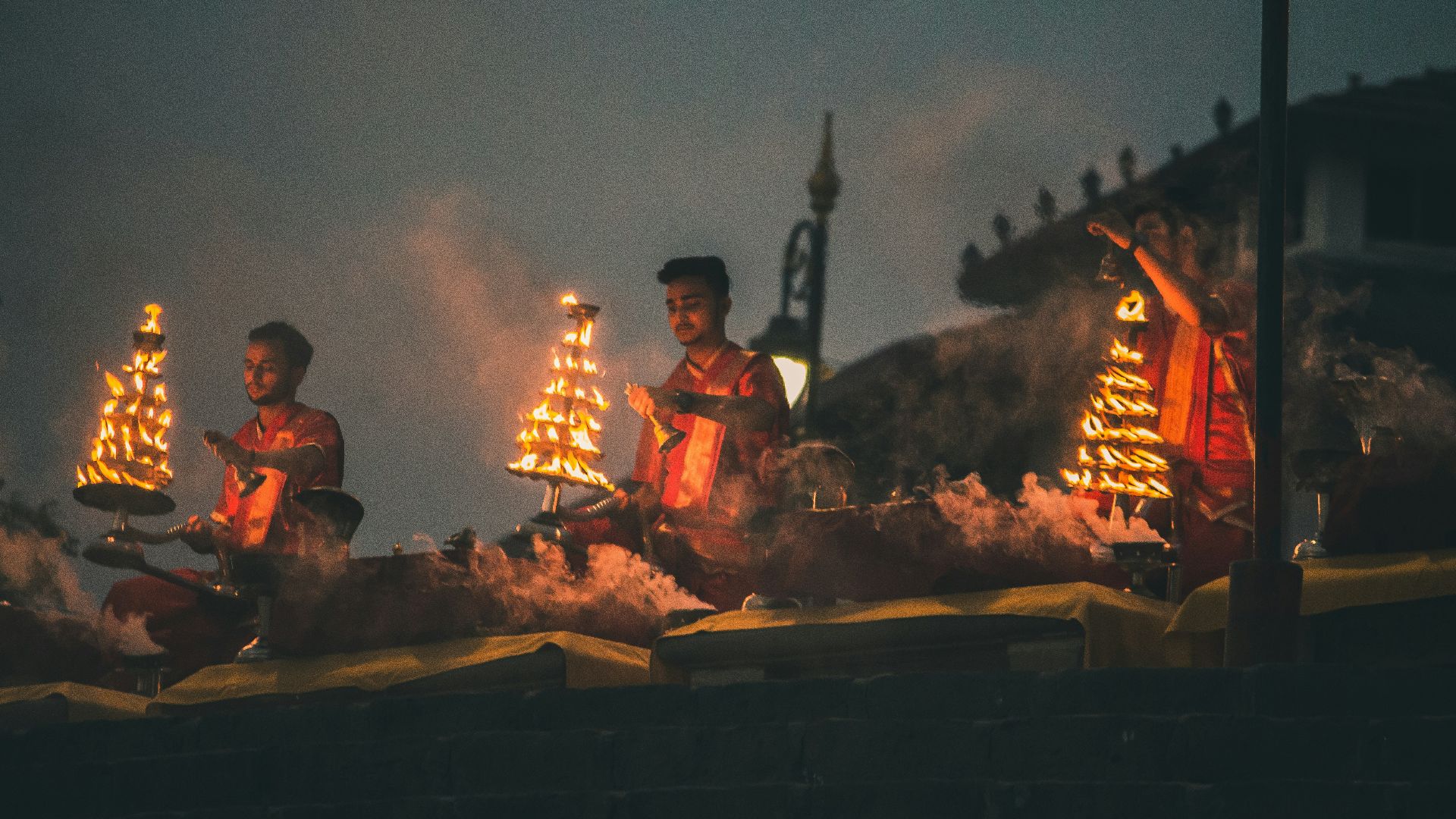 people sitting on brown wooden bench during night time
