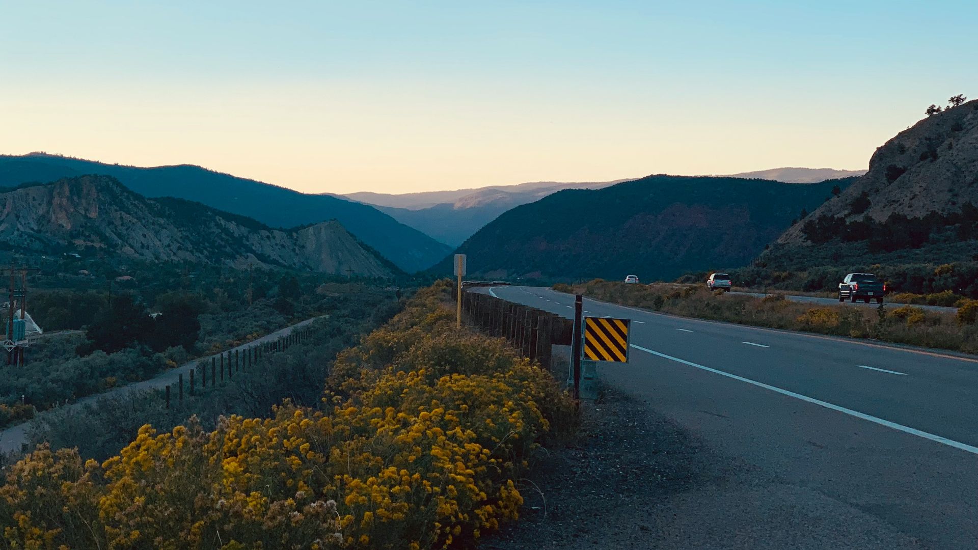 a road with a fence and trees on the side