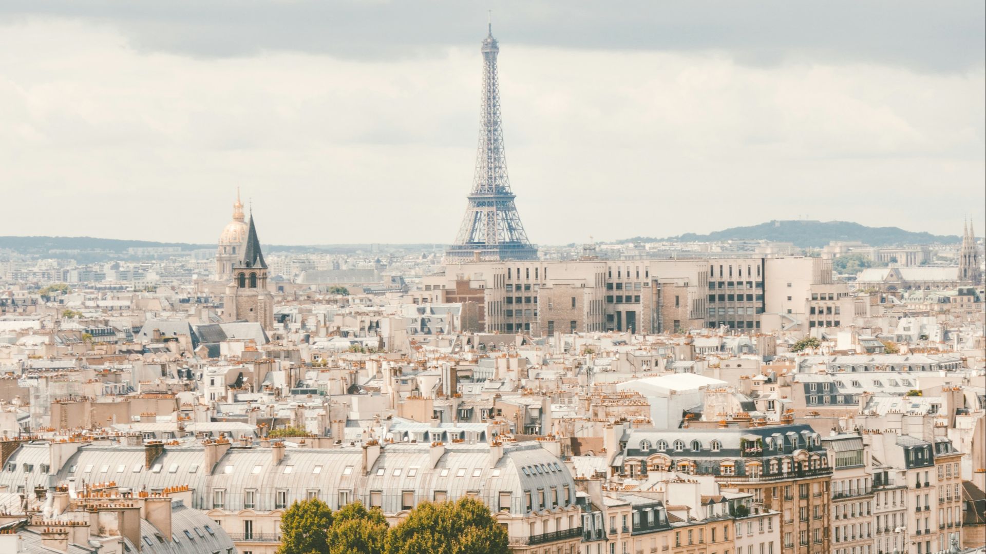 group of people walking near body of water and building under blue sky at daytime