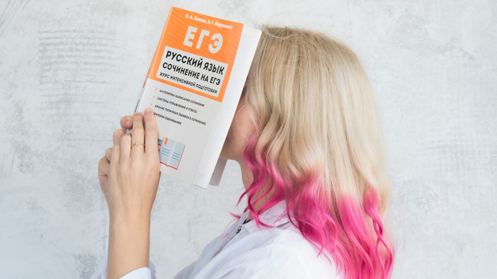 woman in white long sleeve shirt holding white and orange box