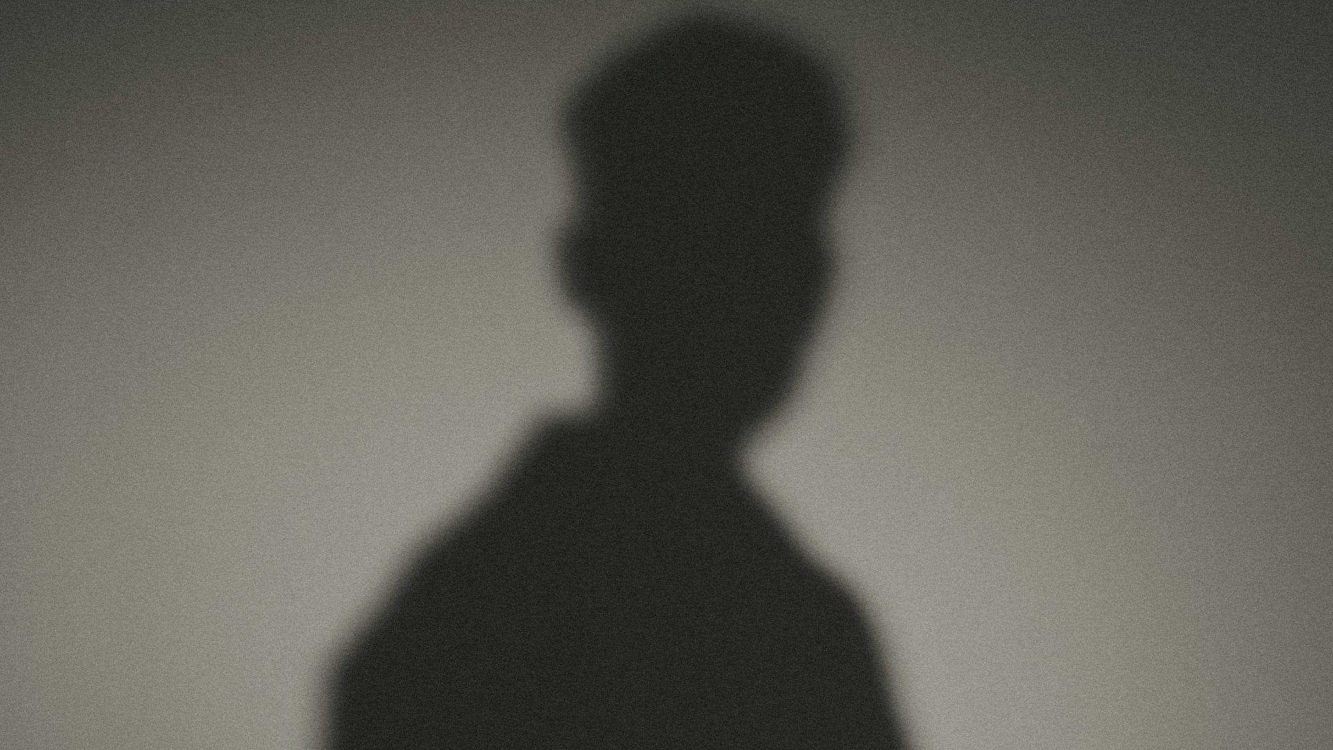 A shadow of a man standing in the dark