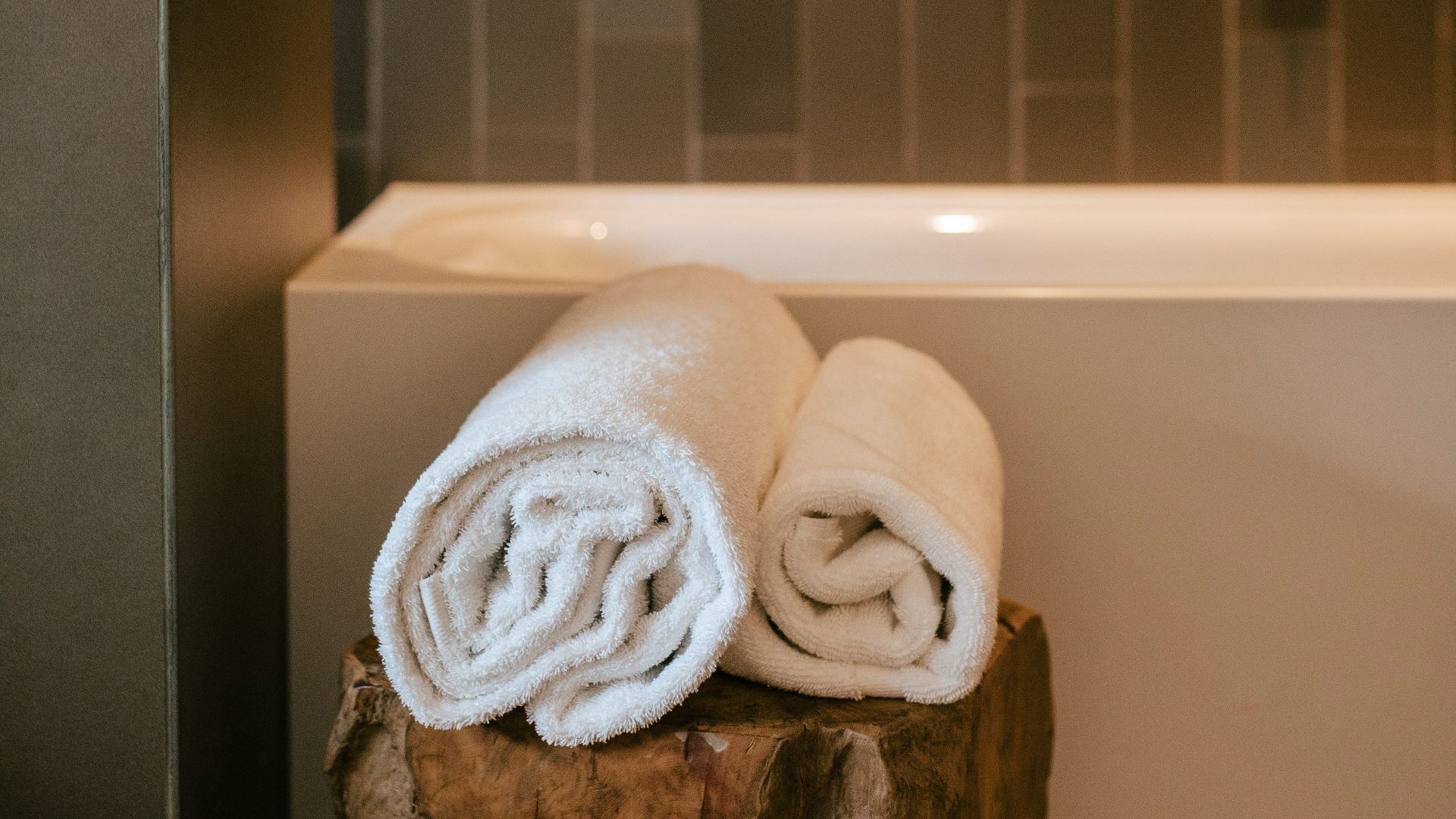 a wooden carving of a tree with a white bow