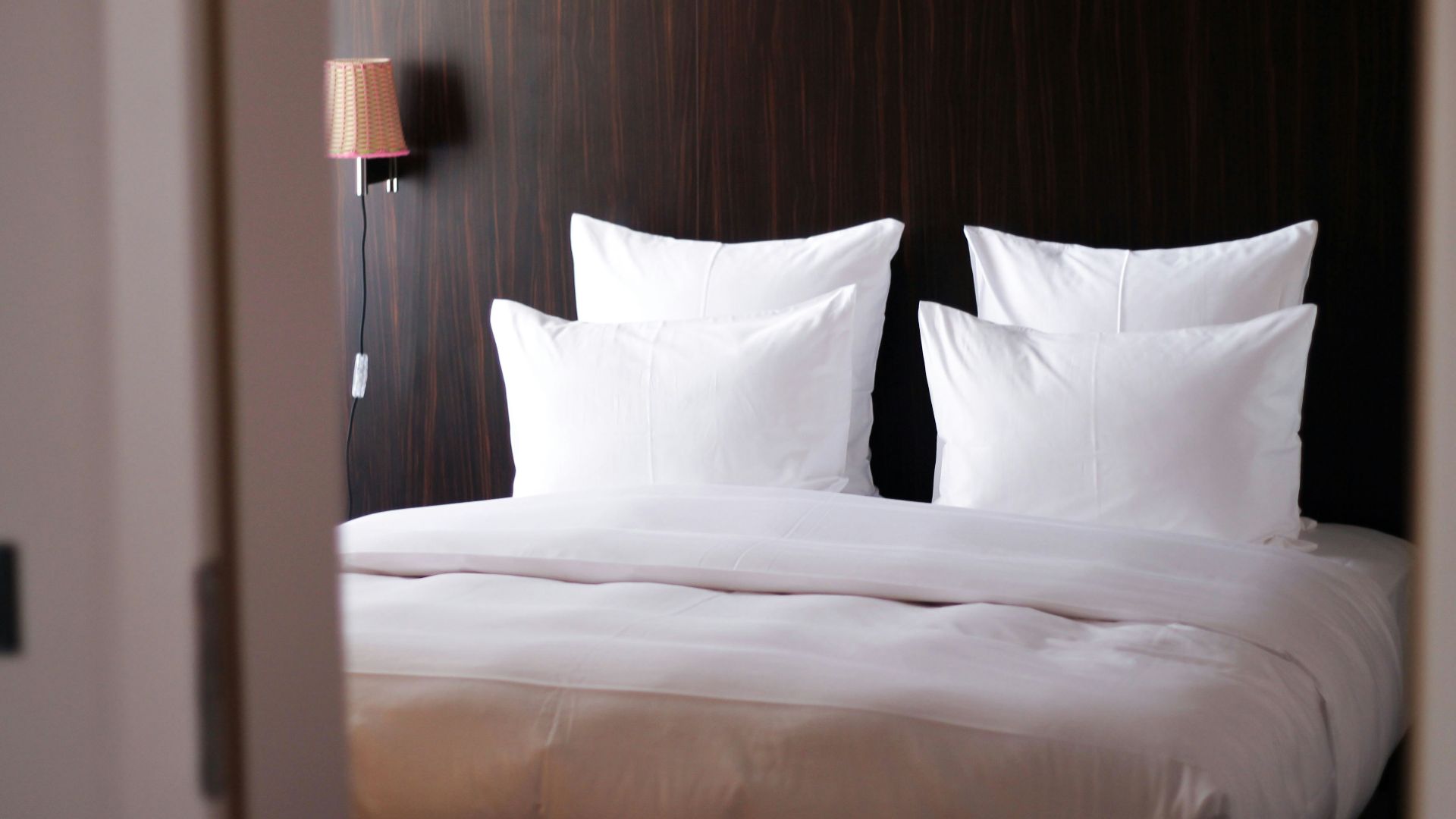 white bed pillow on white bed