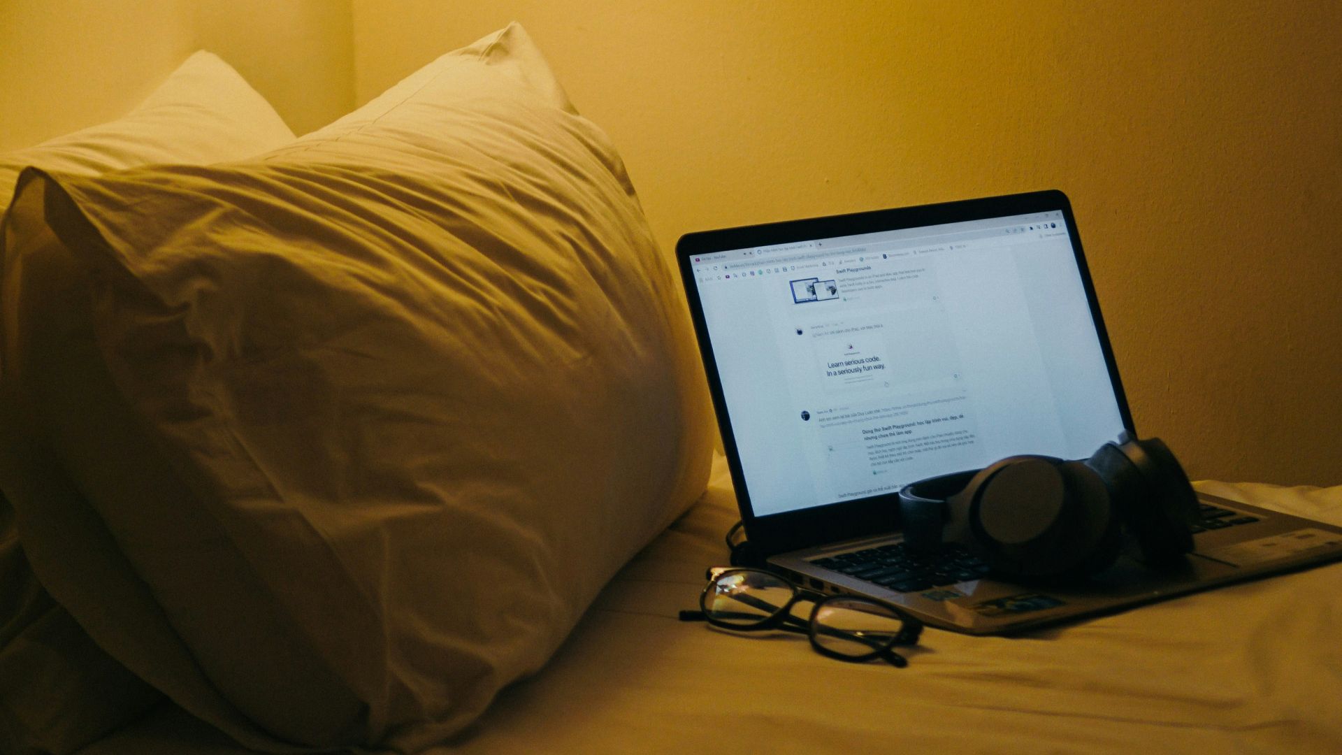 a laptop computer sitting on top of a bed
