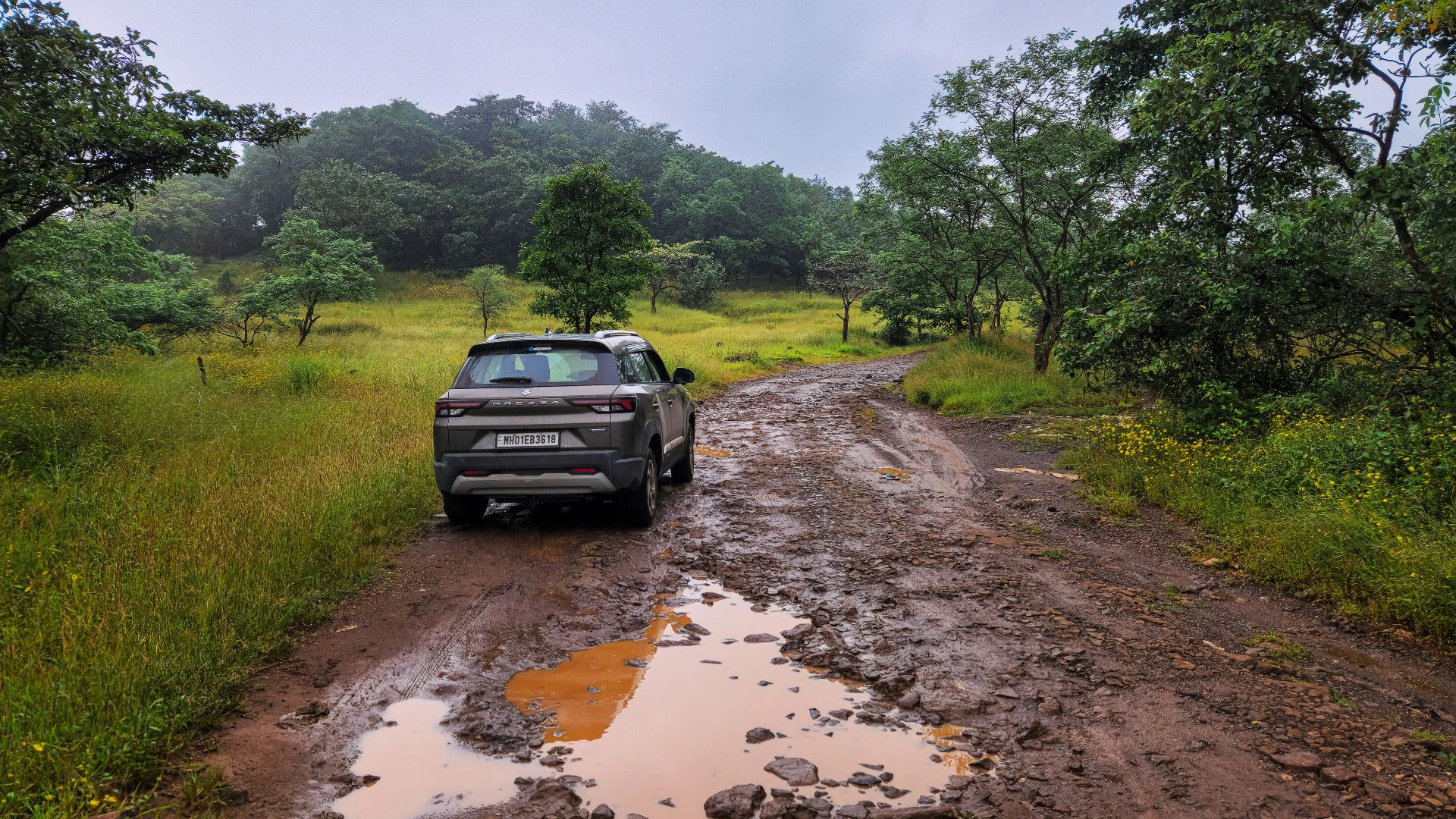 A car is parked on a muddy road