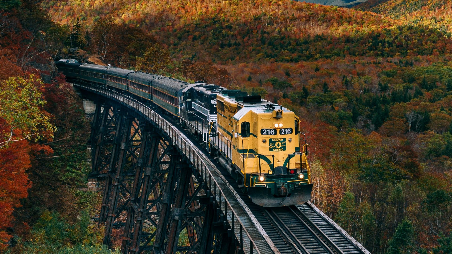 yellow train on rail tracks during daytime