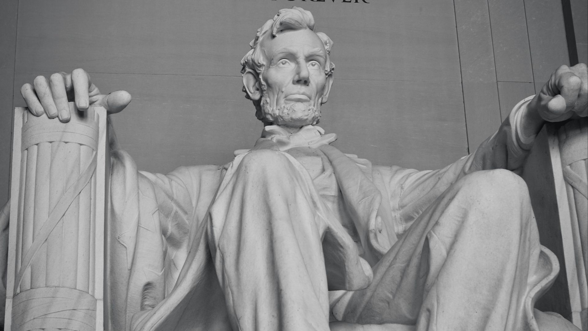 man in robe sitting statue
