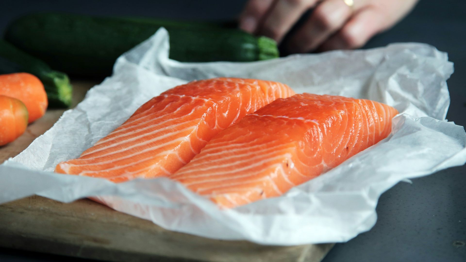 raw fish meat on brown chopping board