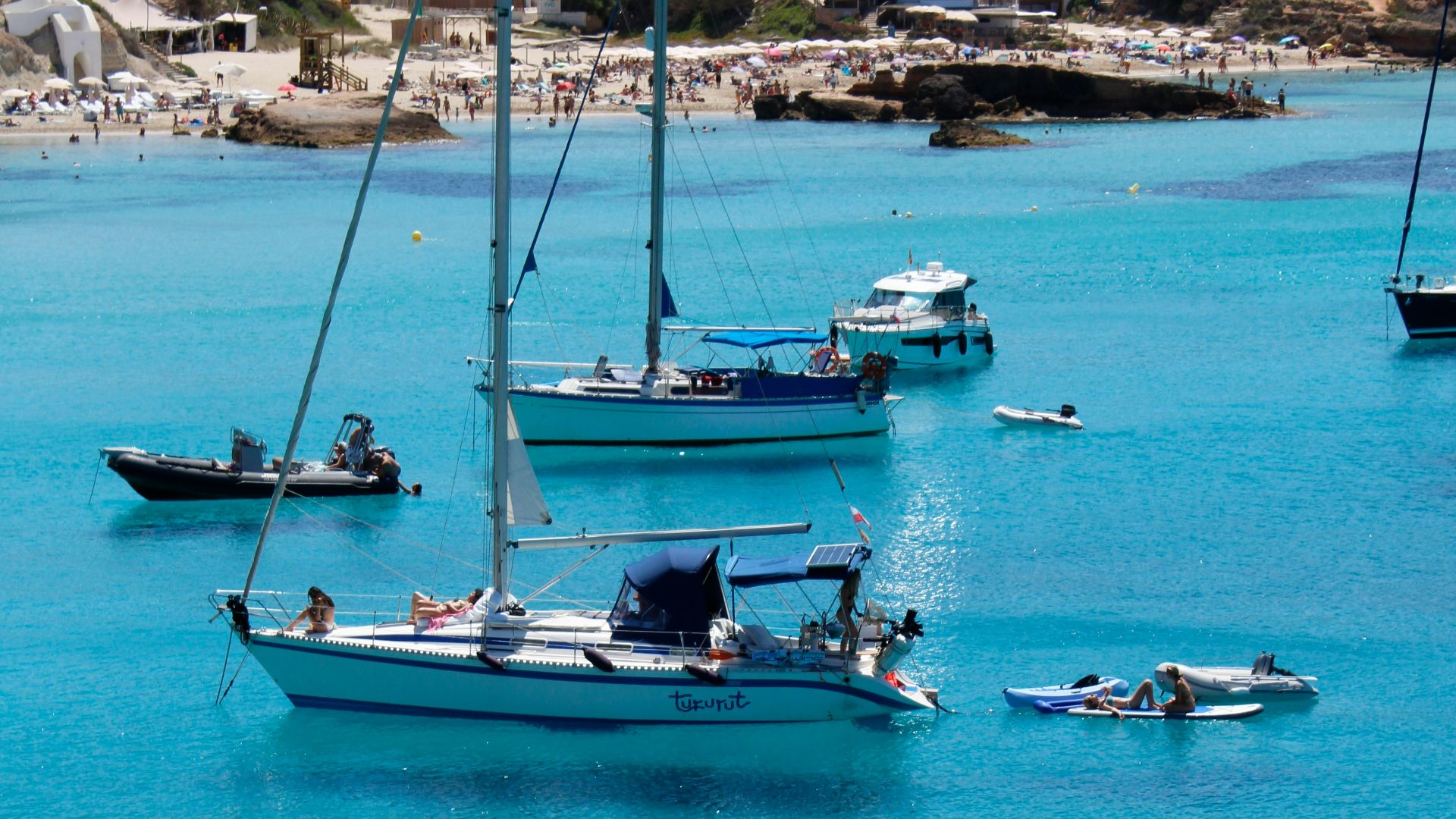 a group of boats floating on top of a body of water