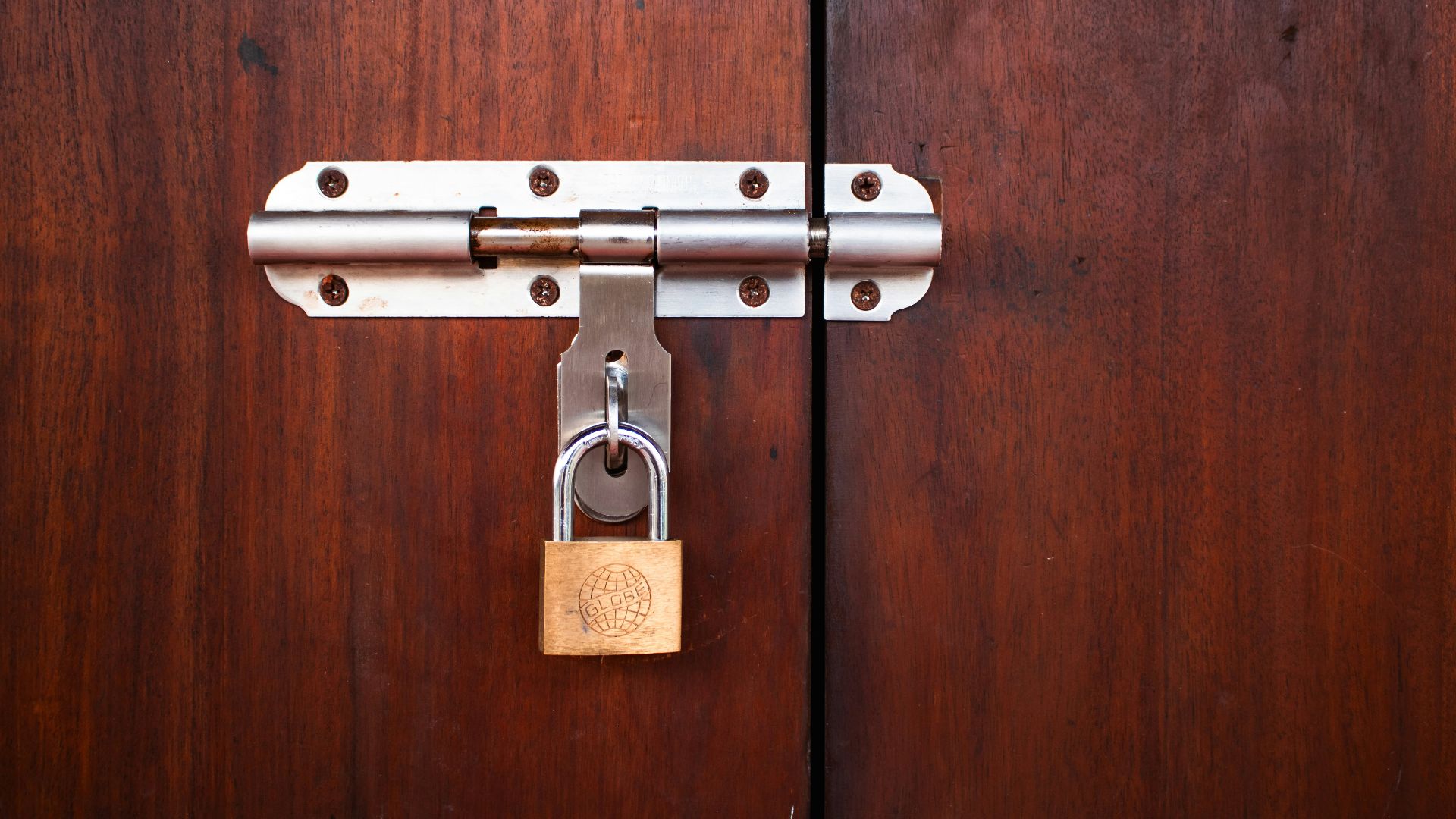A metal lock secures the wooden doors.