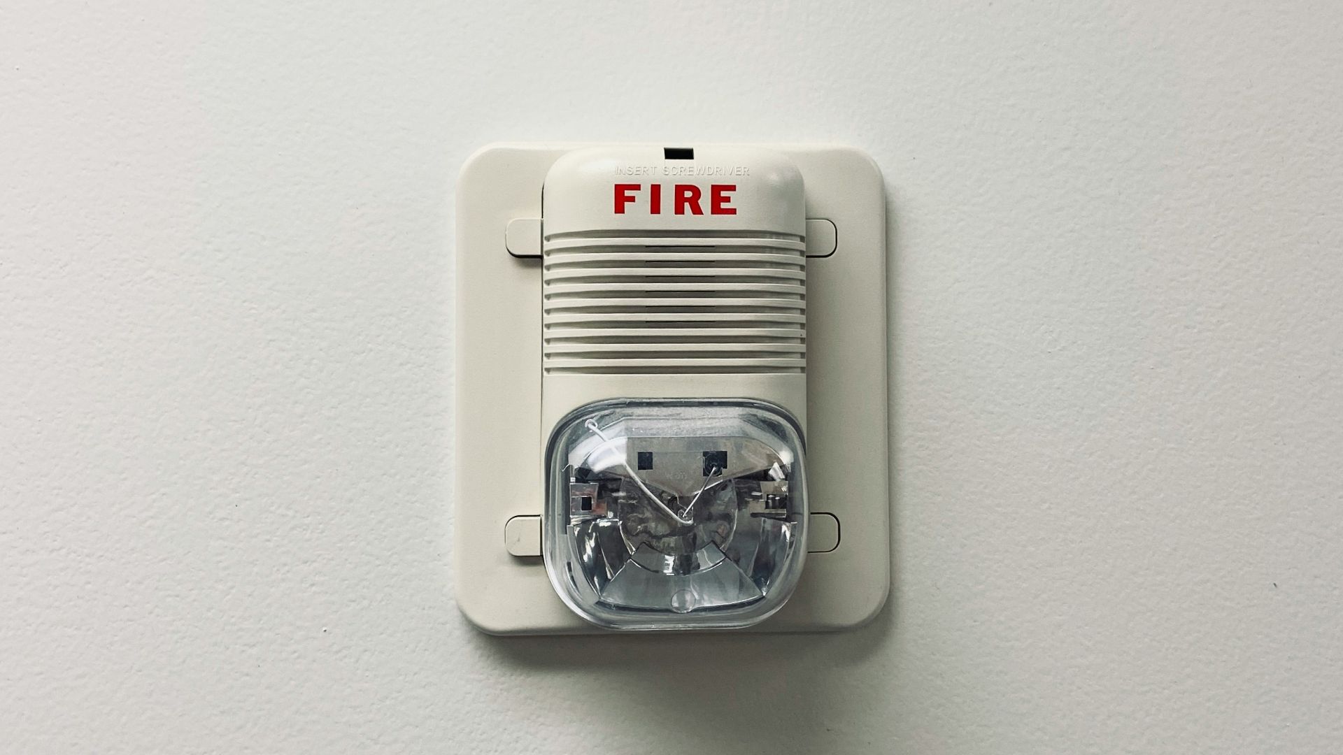 white and black electric device mounted on white wall