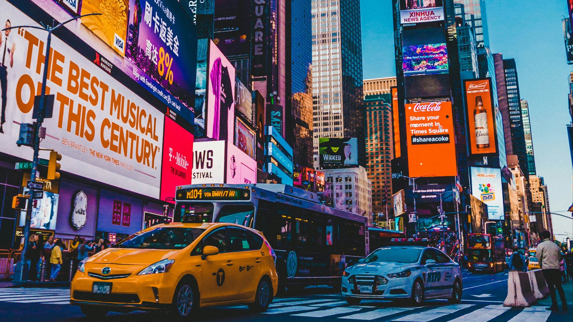 cars parked on street near high rise buildings during night time