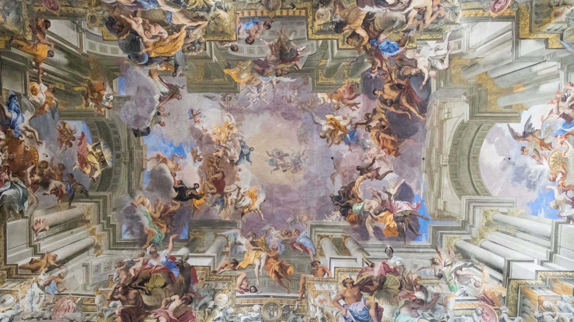 the ceiling of a building with many paintings on it