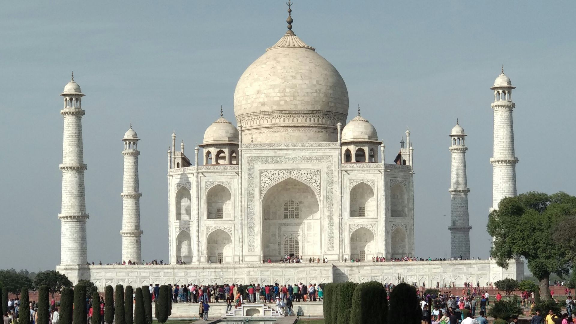 people walking on white concrete building during daytime