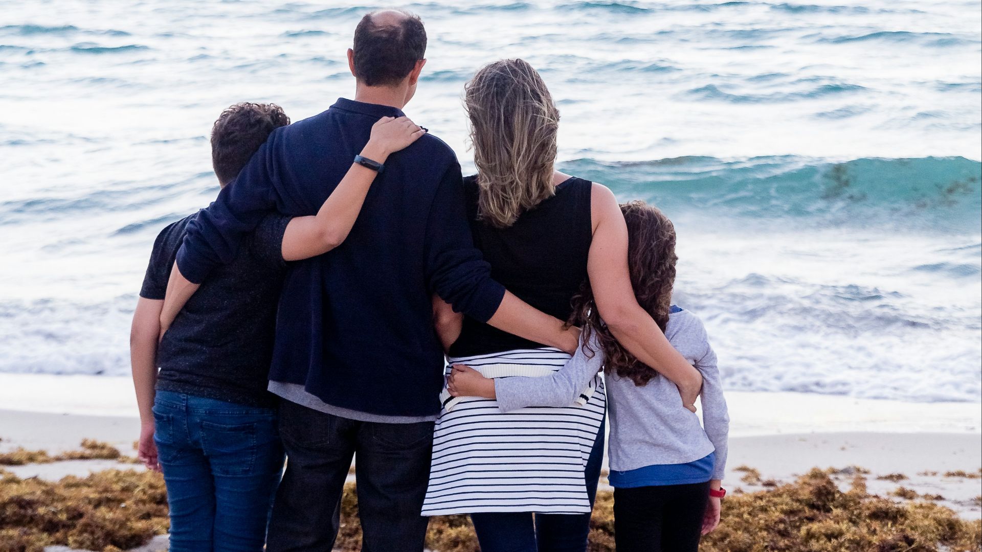 a family of four on a beach