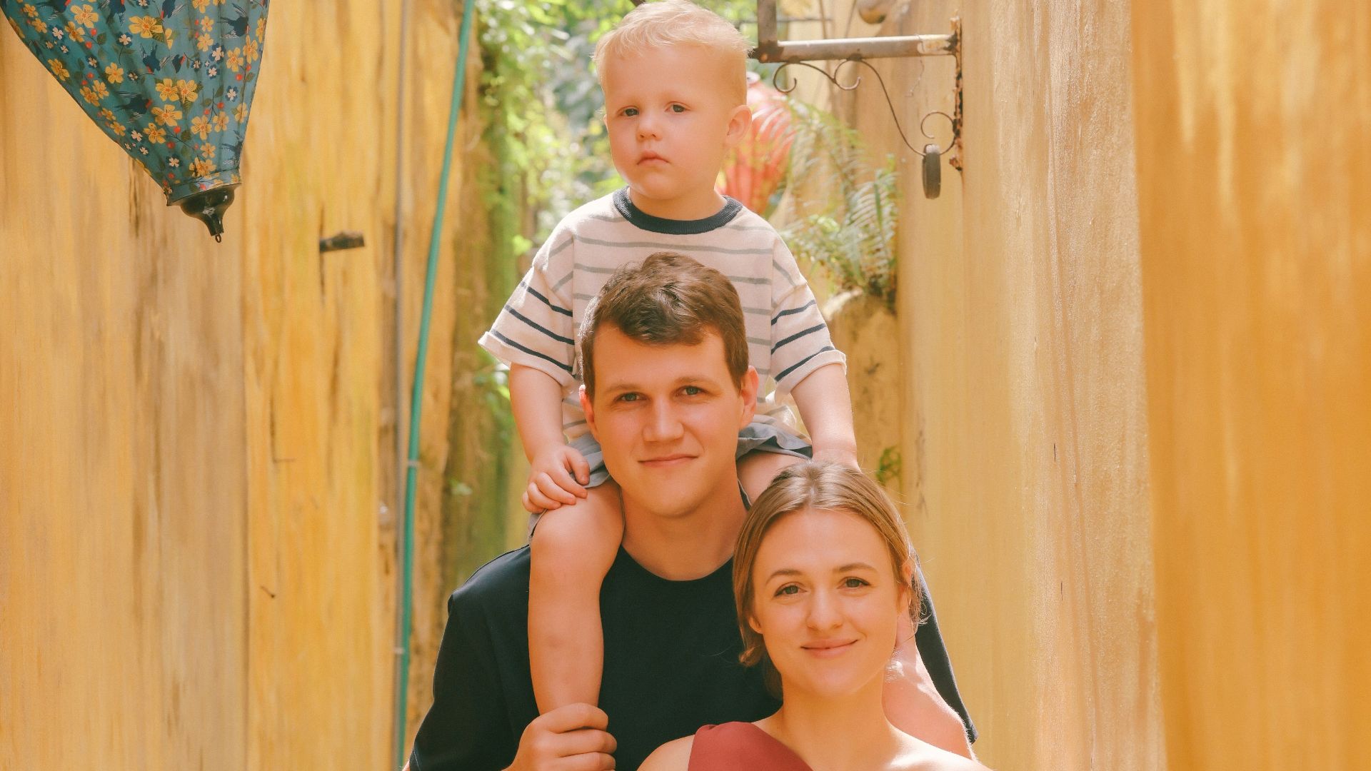 Family posing for a photo in a narrow alleyway