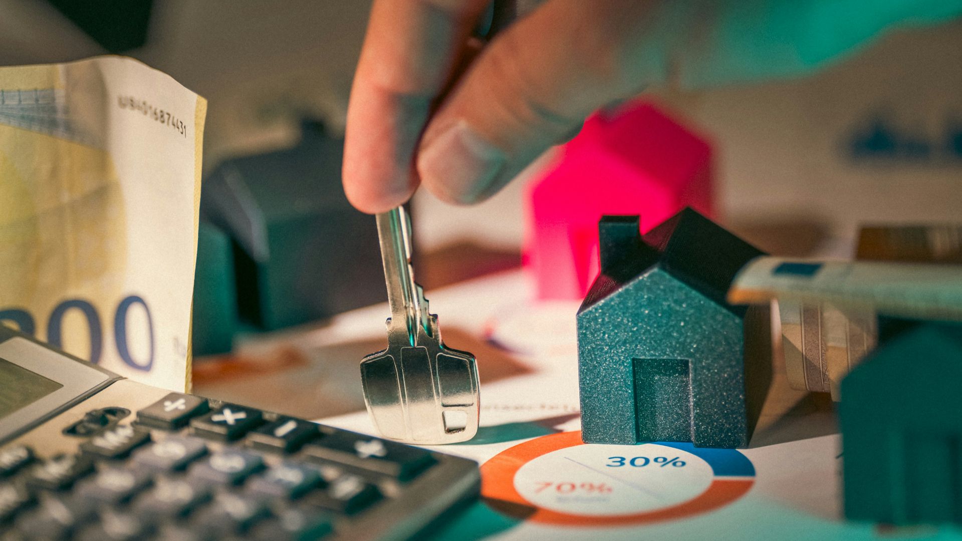 A person putting money into a calculator