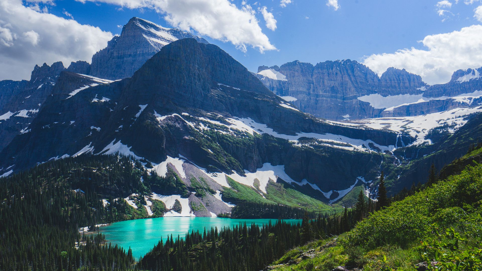 a view of a mountain range with a lake in the foreground