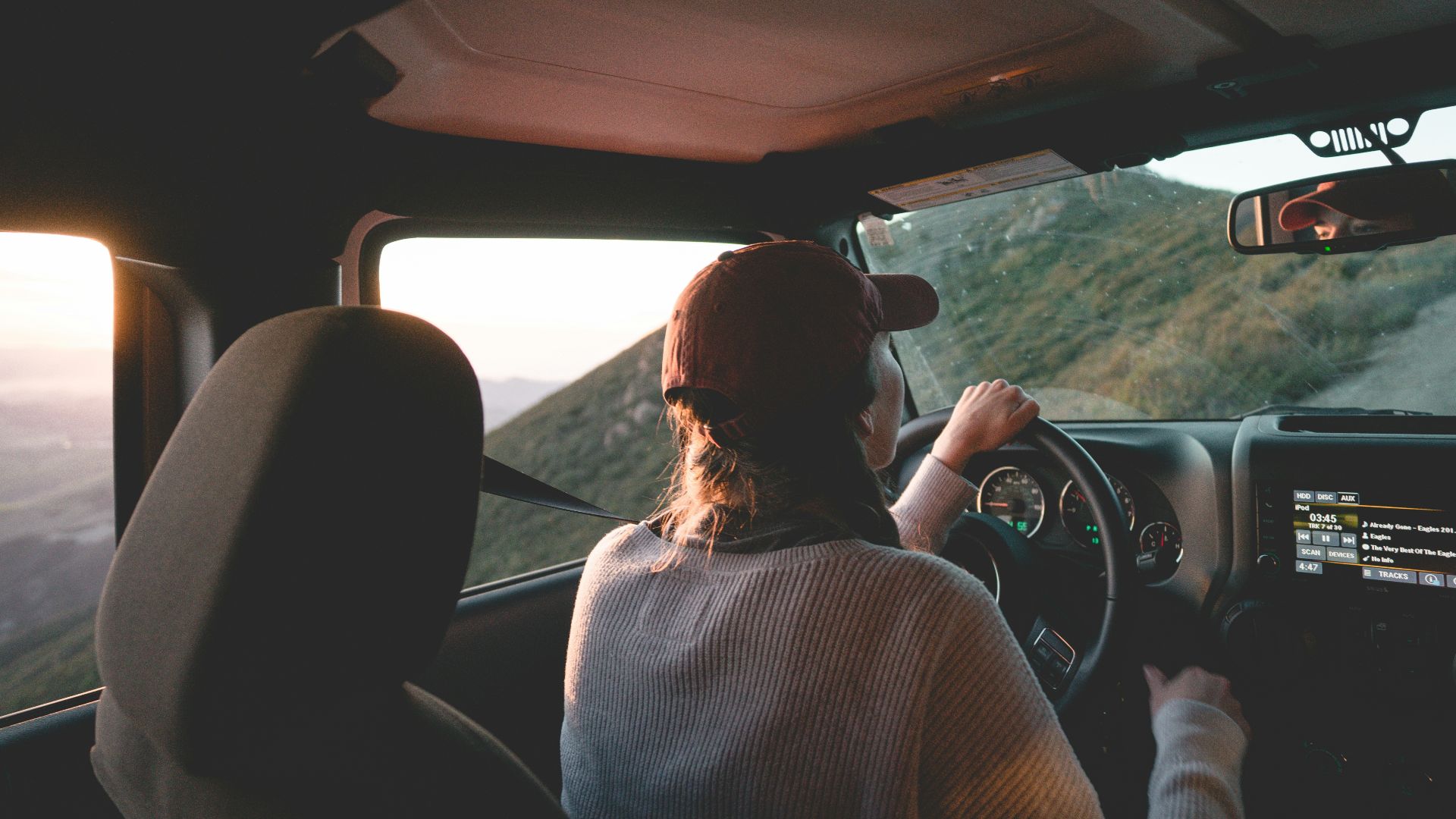woman driving vehicle on road during daytime