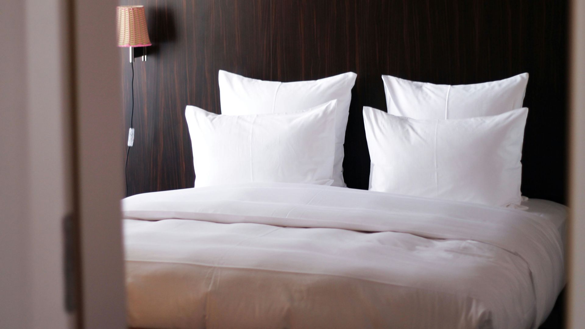 white bed pillow on white bed