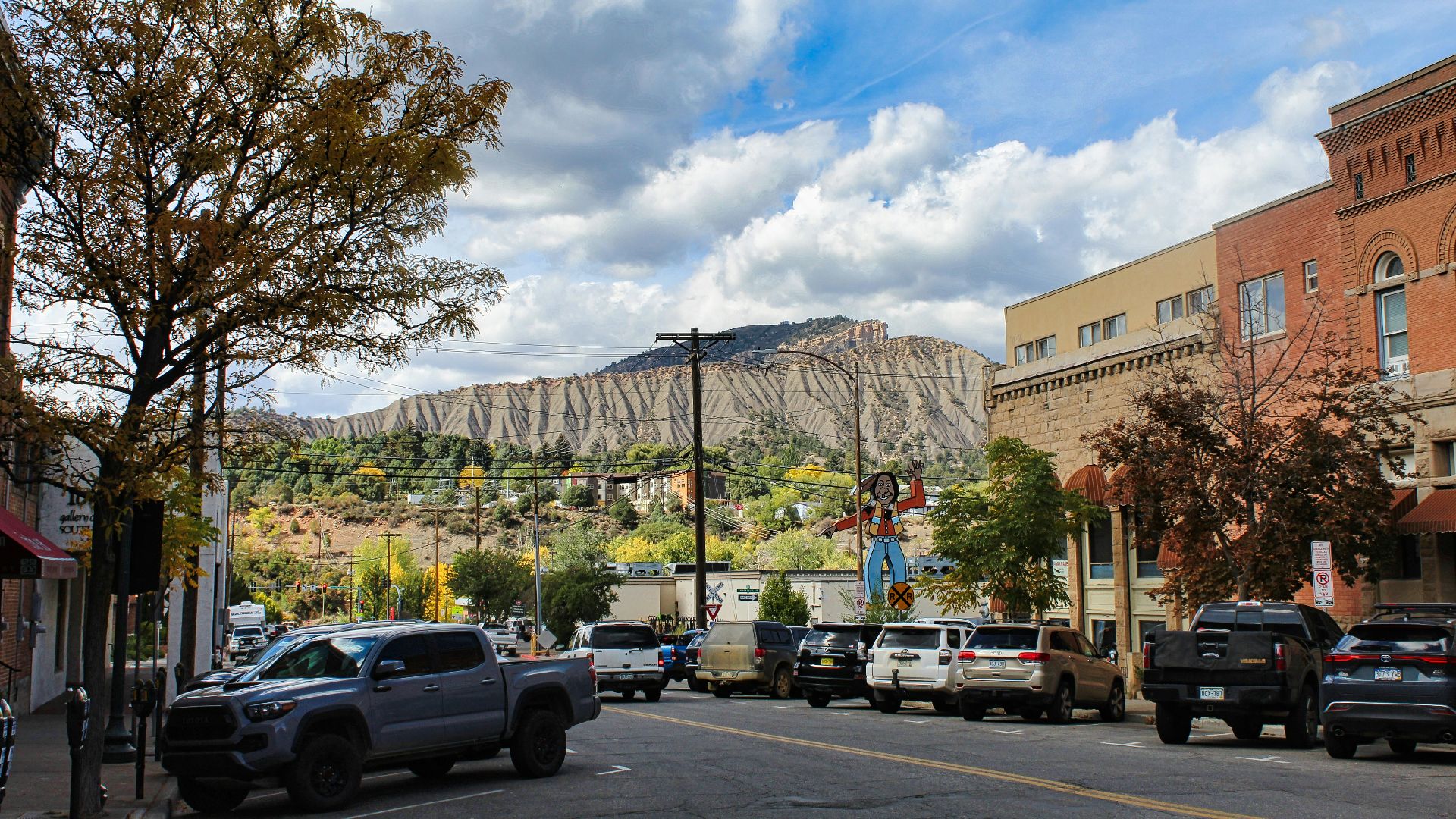 a city street with a mountain in the background