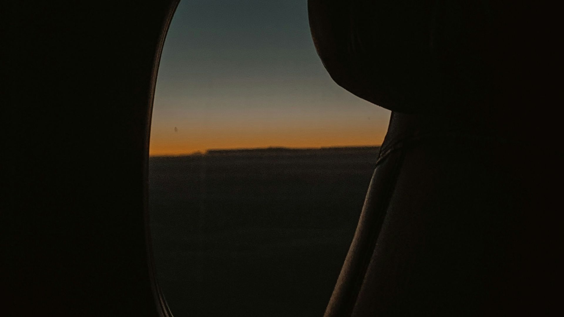 a view of a sunset from an airplane window
