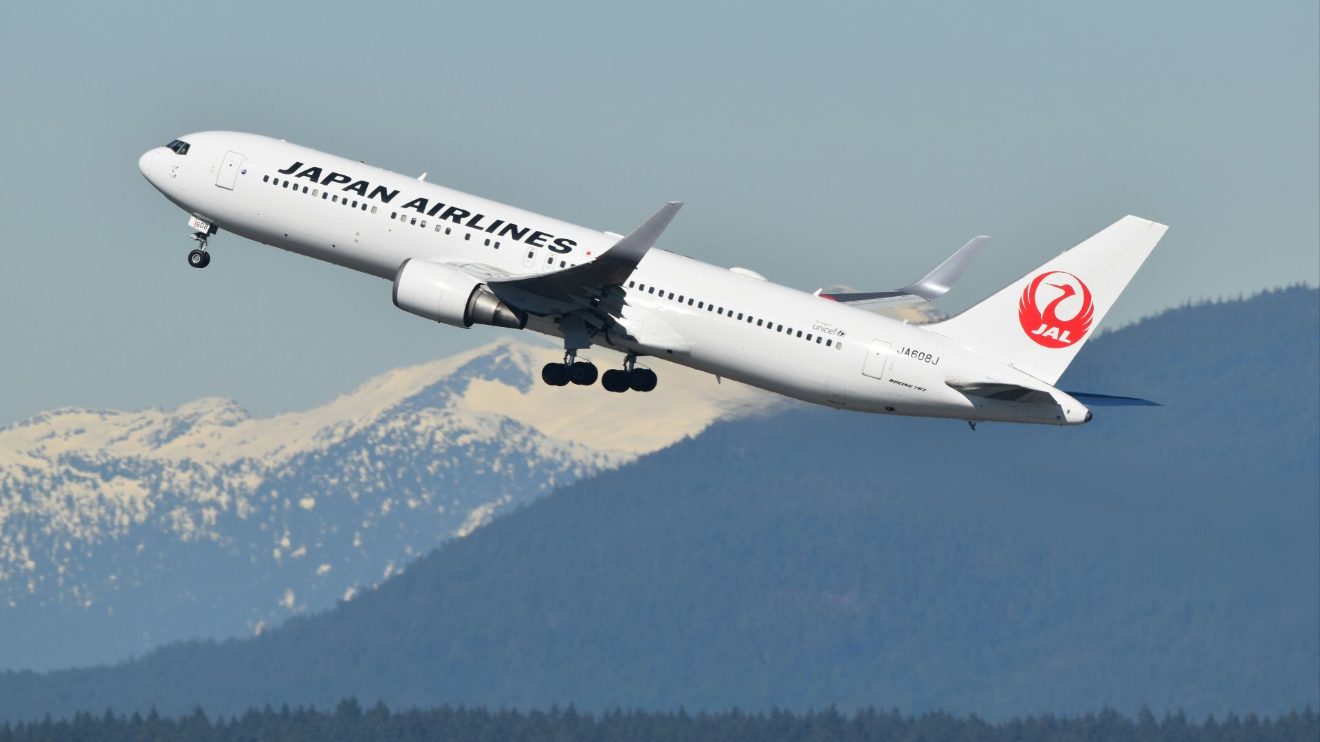 A large jetliner flying through a blue sky
