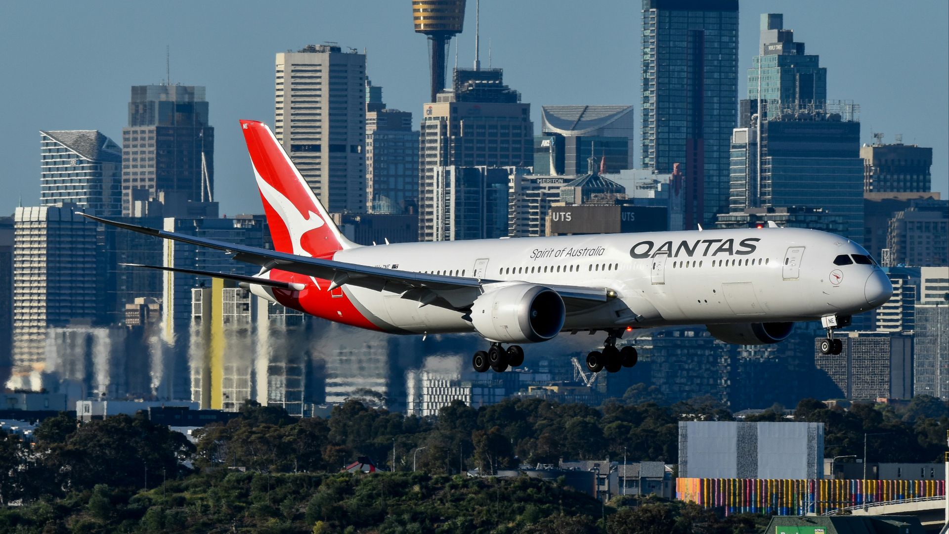 A large passenger jet flying over a city