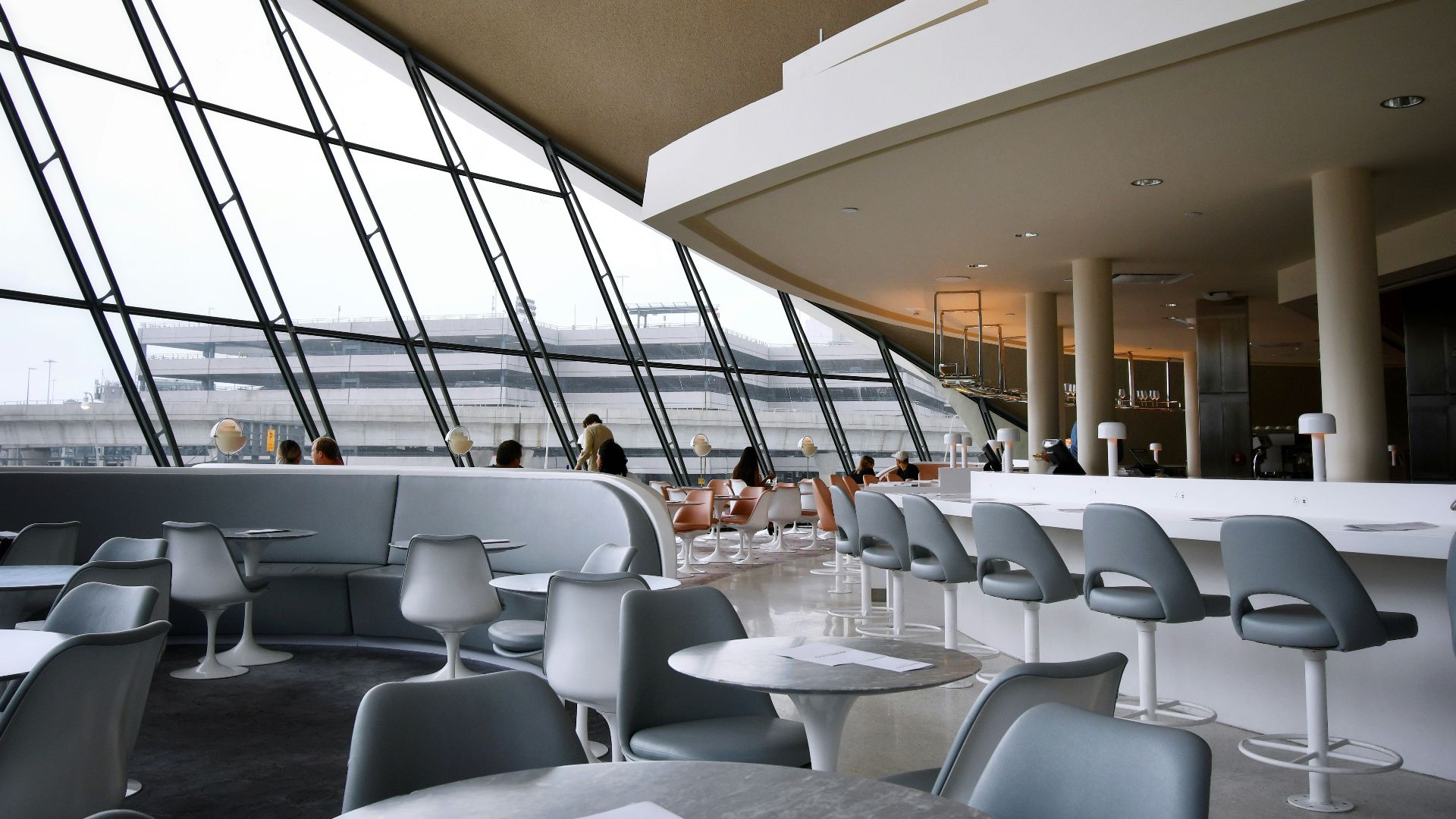 people sitting on white chairs inside building
