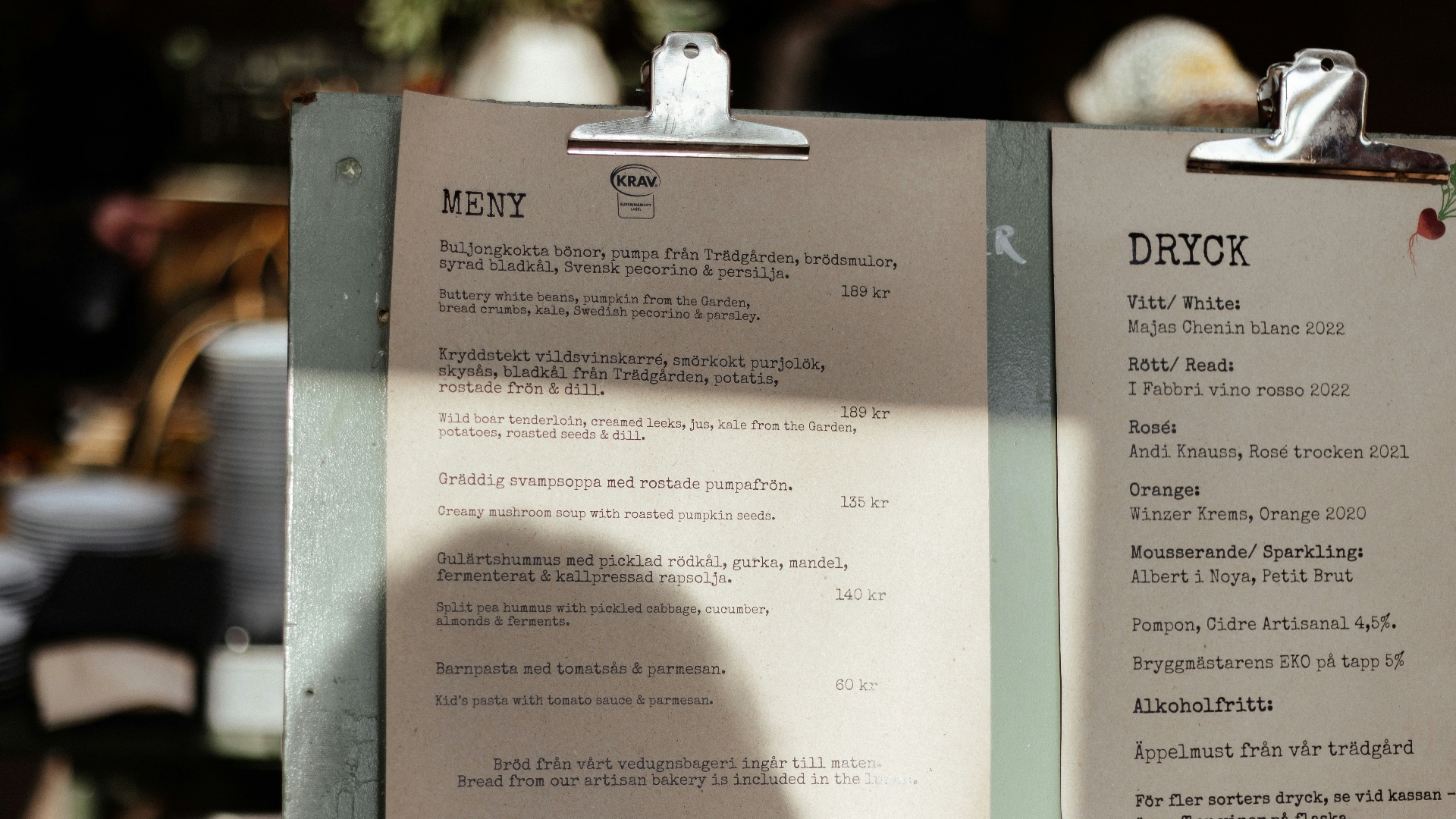 A menu sitting on top of a table next to a cup of coffee