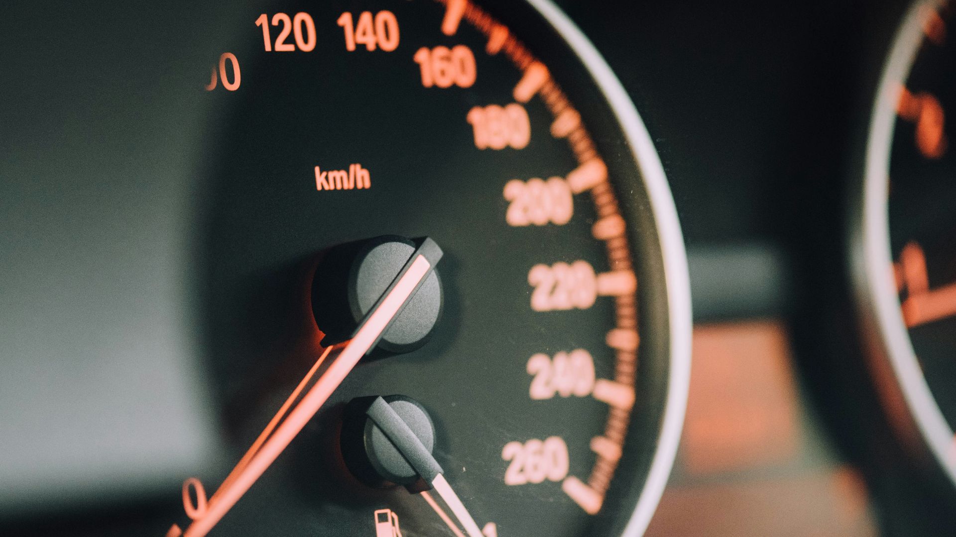 closeup photo of black analog speedometer