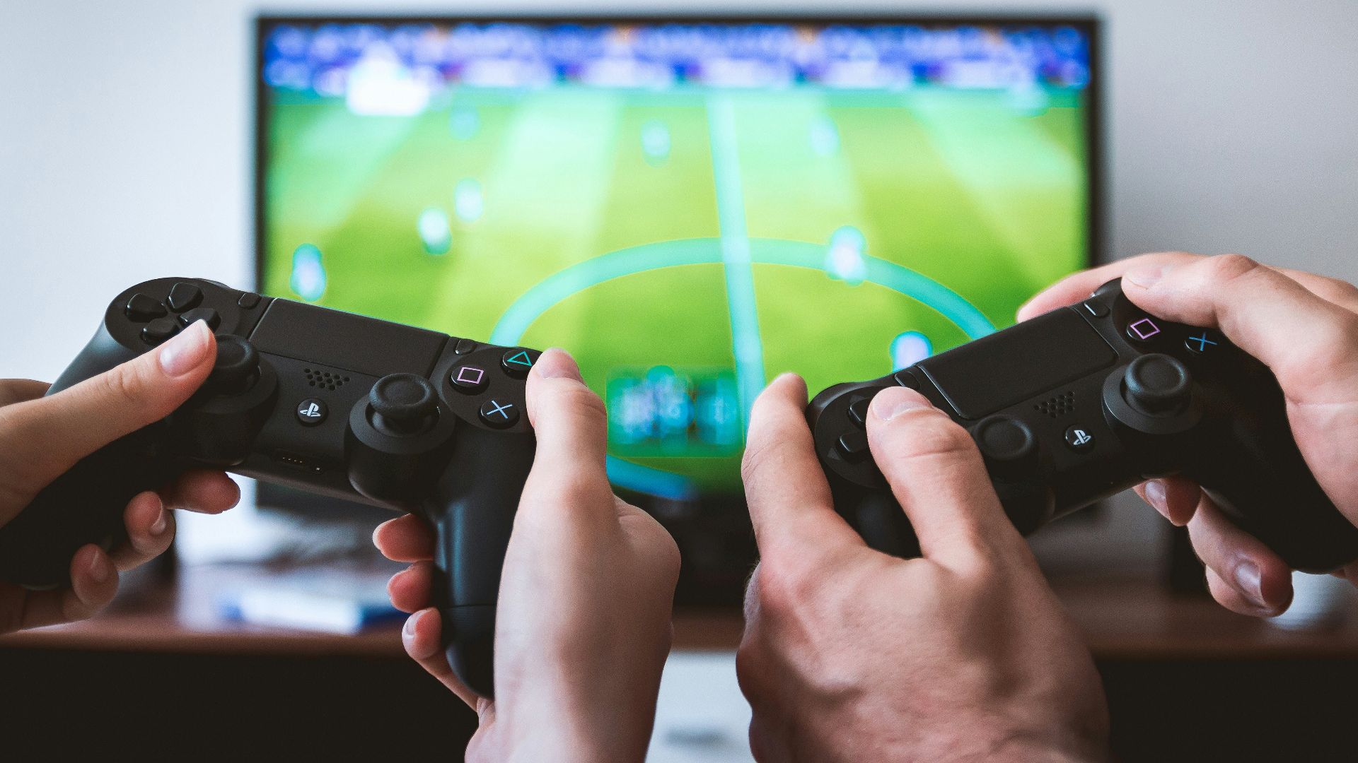 two people playing Sony PS4 game console